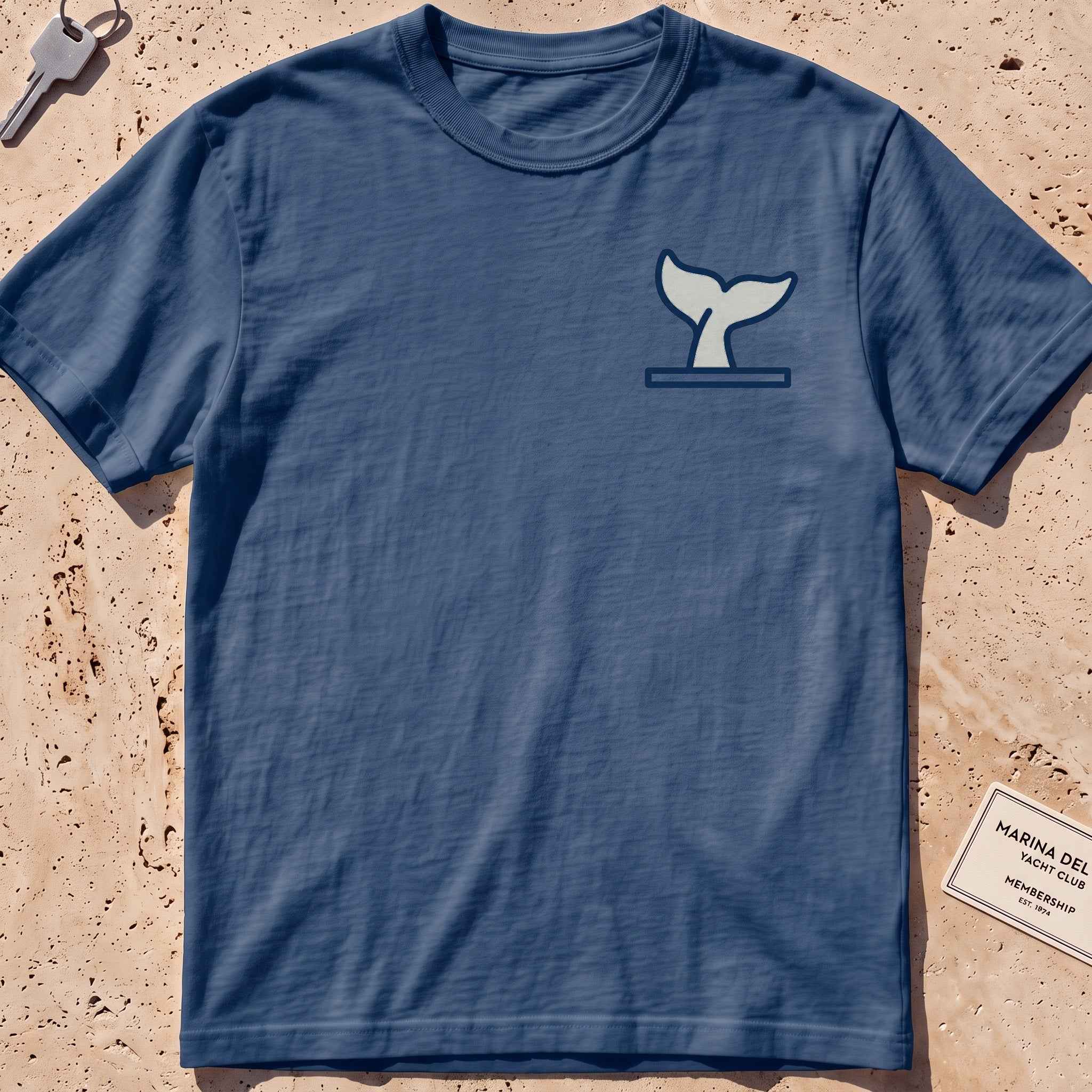 midnight heavyweight tee with a diving whale-fluke crest graphic.