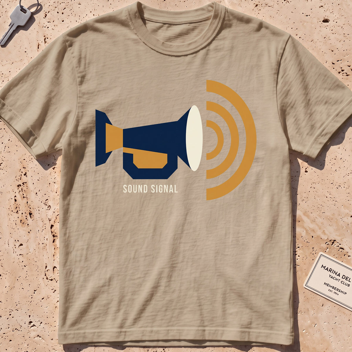 khaki heavyweight tee with a flat-geometric foghorn "Sound Signal" graphic.