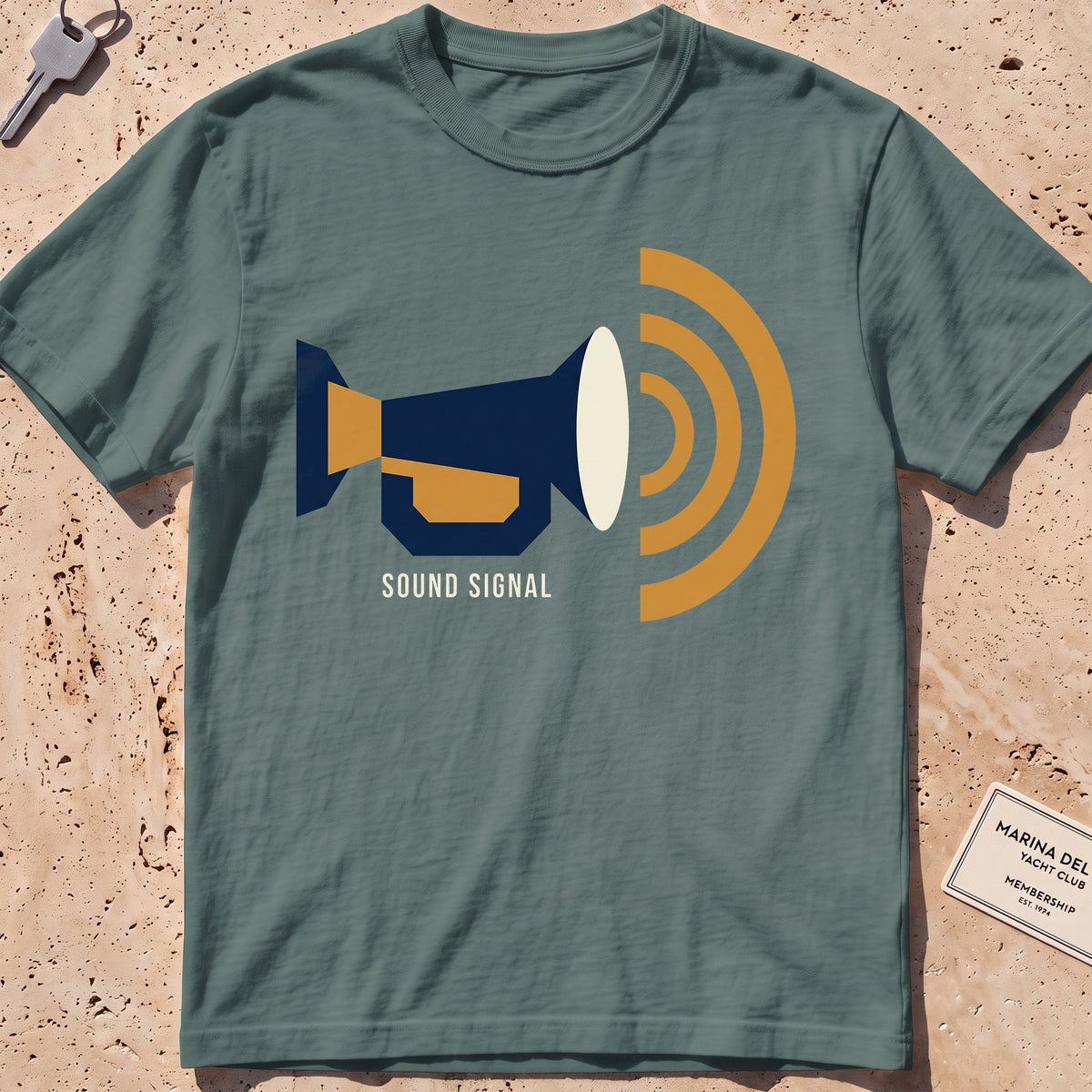 blue spruce heavyweight tee with a flat-geometric foghorn "Sound Signal" graphic.