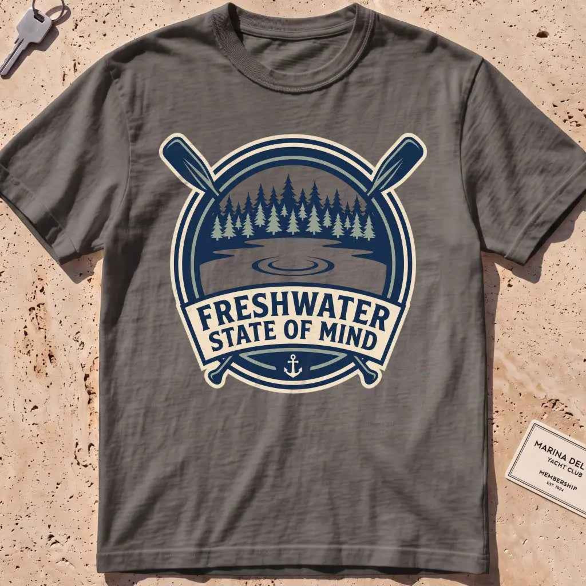 pepper heavyweight tee with a lake-and-pines "Freshwater State of Mind" crest.