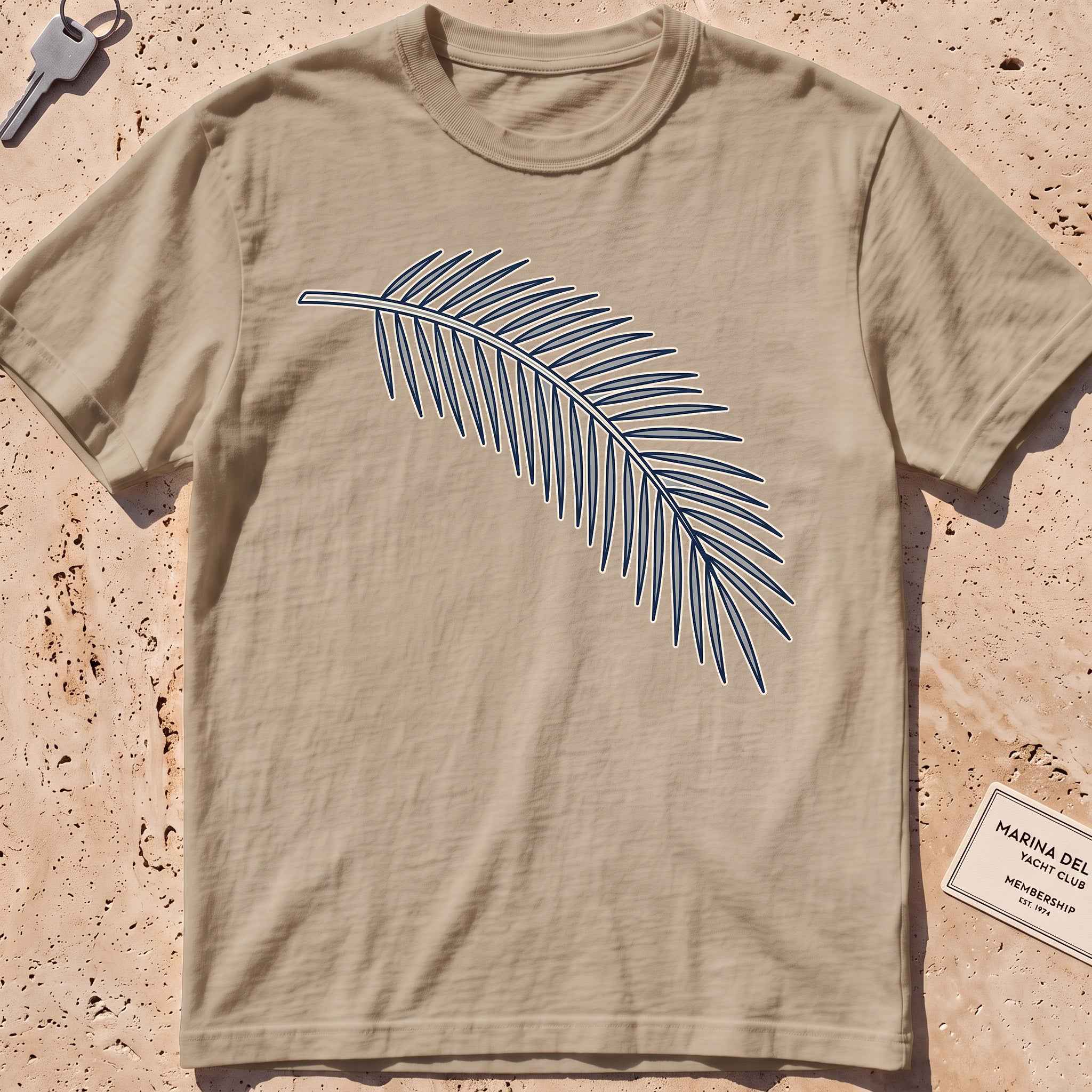 khaki heavyweight tee with a single-line palm frond graphic.