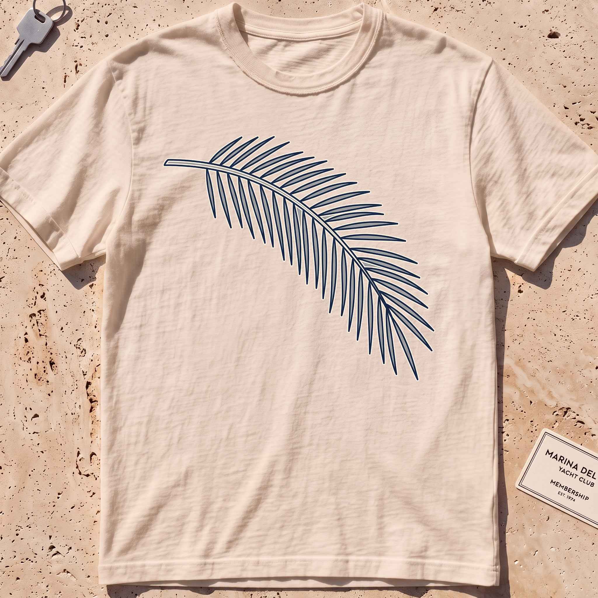 ivory heavyweight tee with a single-line palm frond graphic.