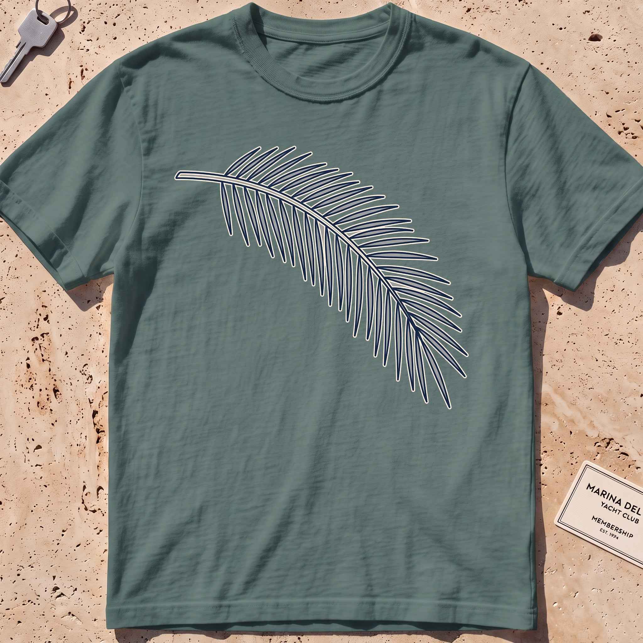 blue spruce heavyweight tee with a single-line palm frond graphic.