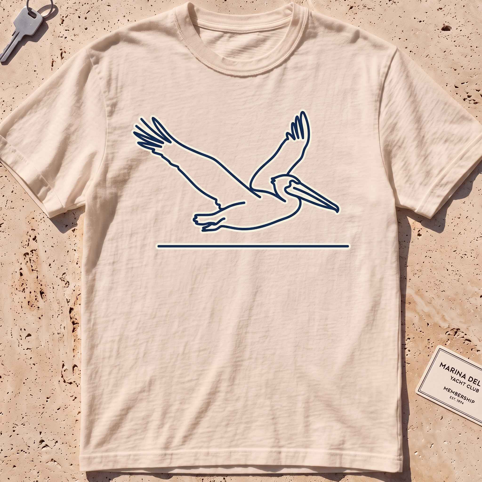 ivory heavyweight tee with a single-line gliding pelican graphic.
