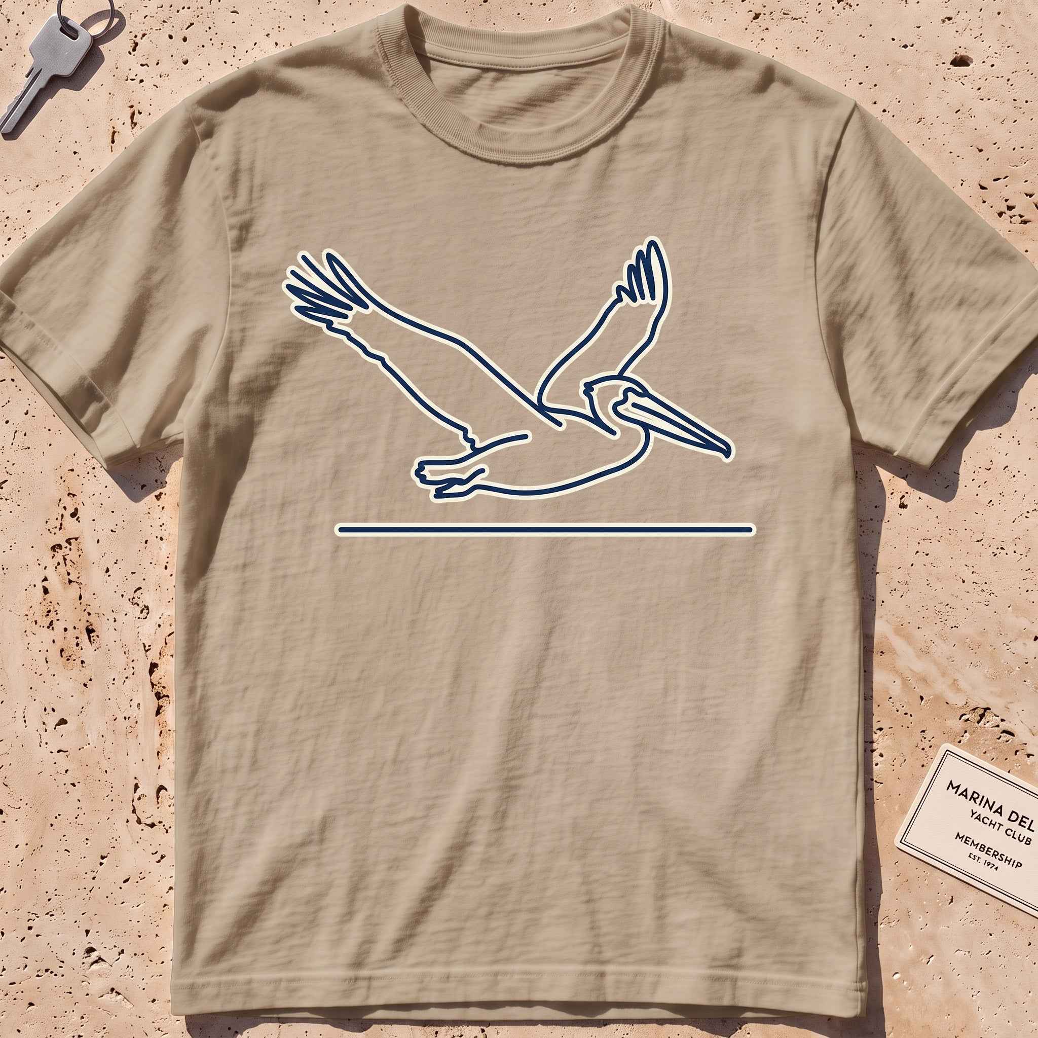 khaki heavyweight tee with a single-line gliding pelican graphic.