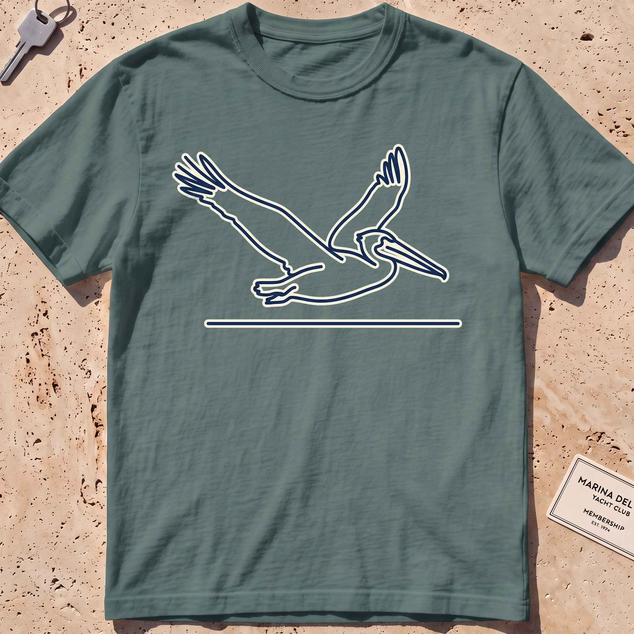 blue spruce heavyweight tee with a single-line gliding pelican graphic.