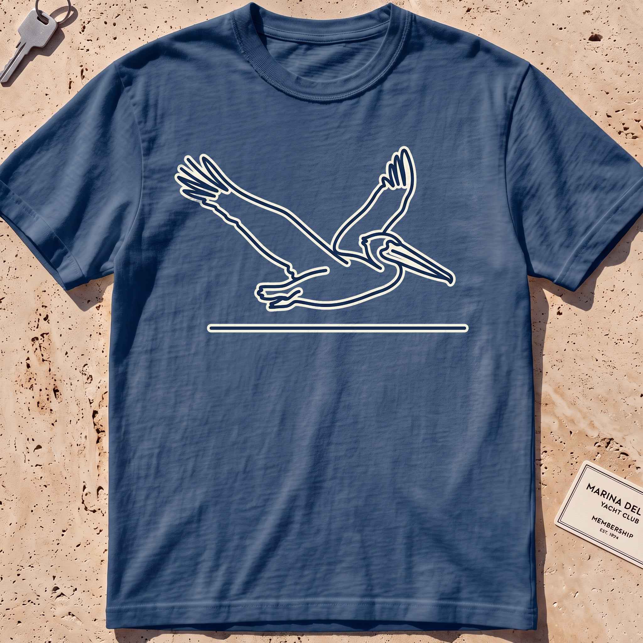 midnight heavyweight tee with a single-line gliding pelican graphic.