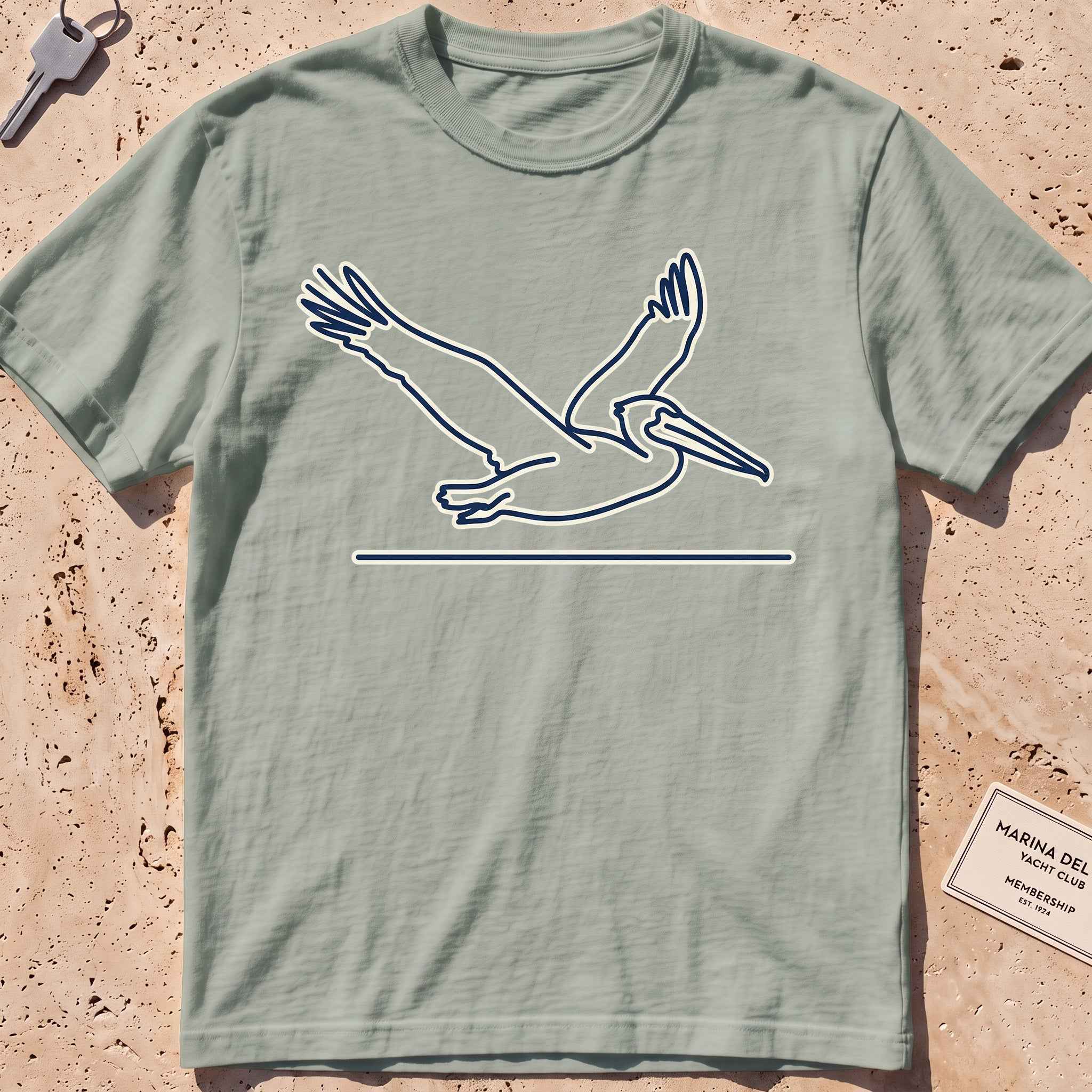 bay heavyweight tee with a single-line gliding pelican graphic.