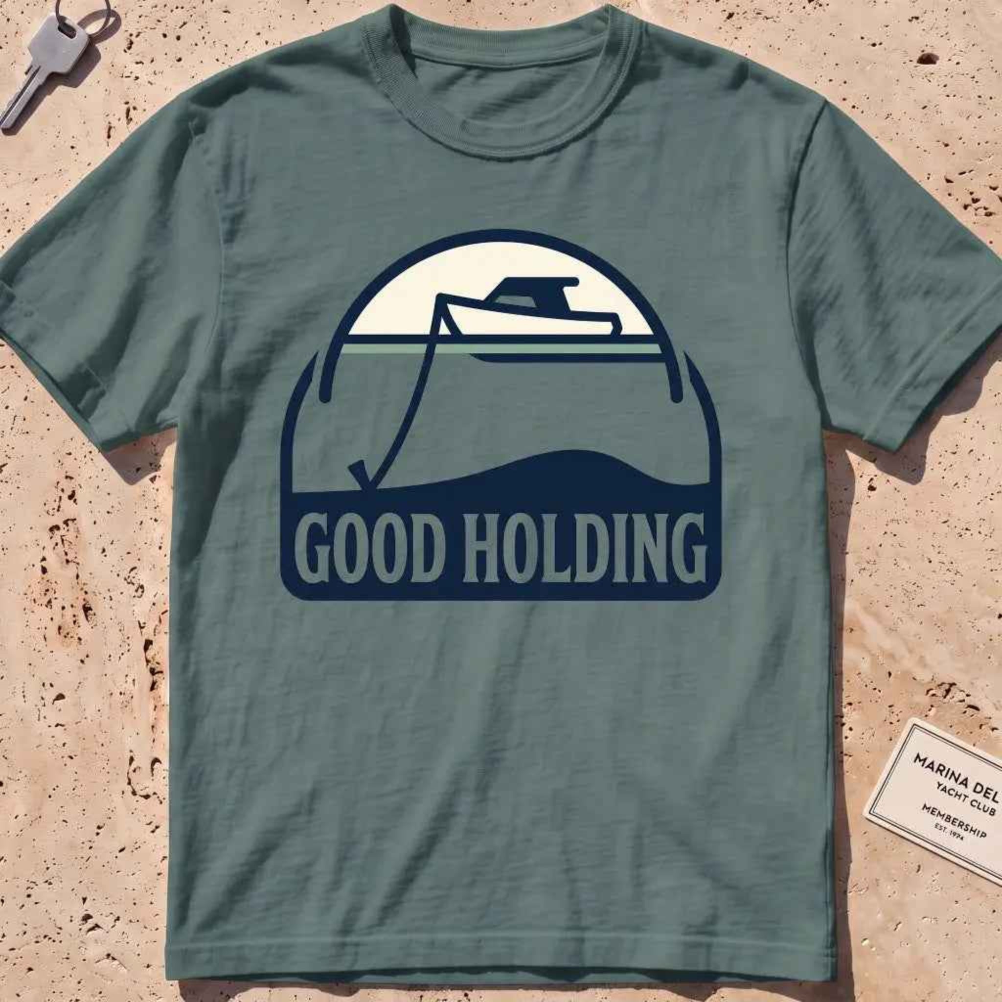 blue spruce heavyweight tee with a boat and anchor-rode "Good Holding" badge.