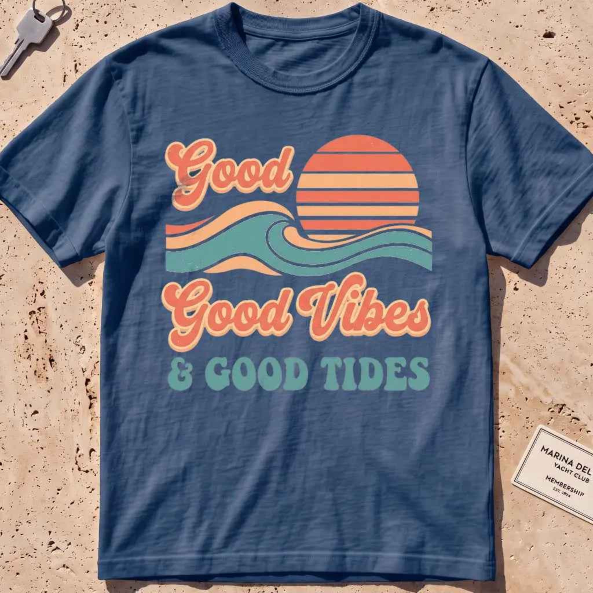 midnight heavyweight tee with retro "Good Vibes and Good Tides" sun-and-wave script.