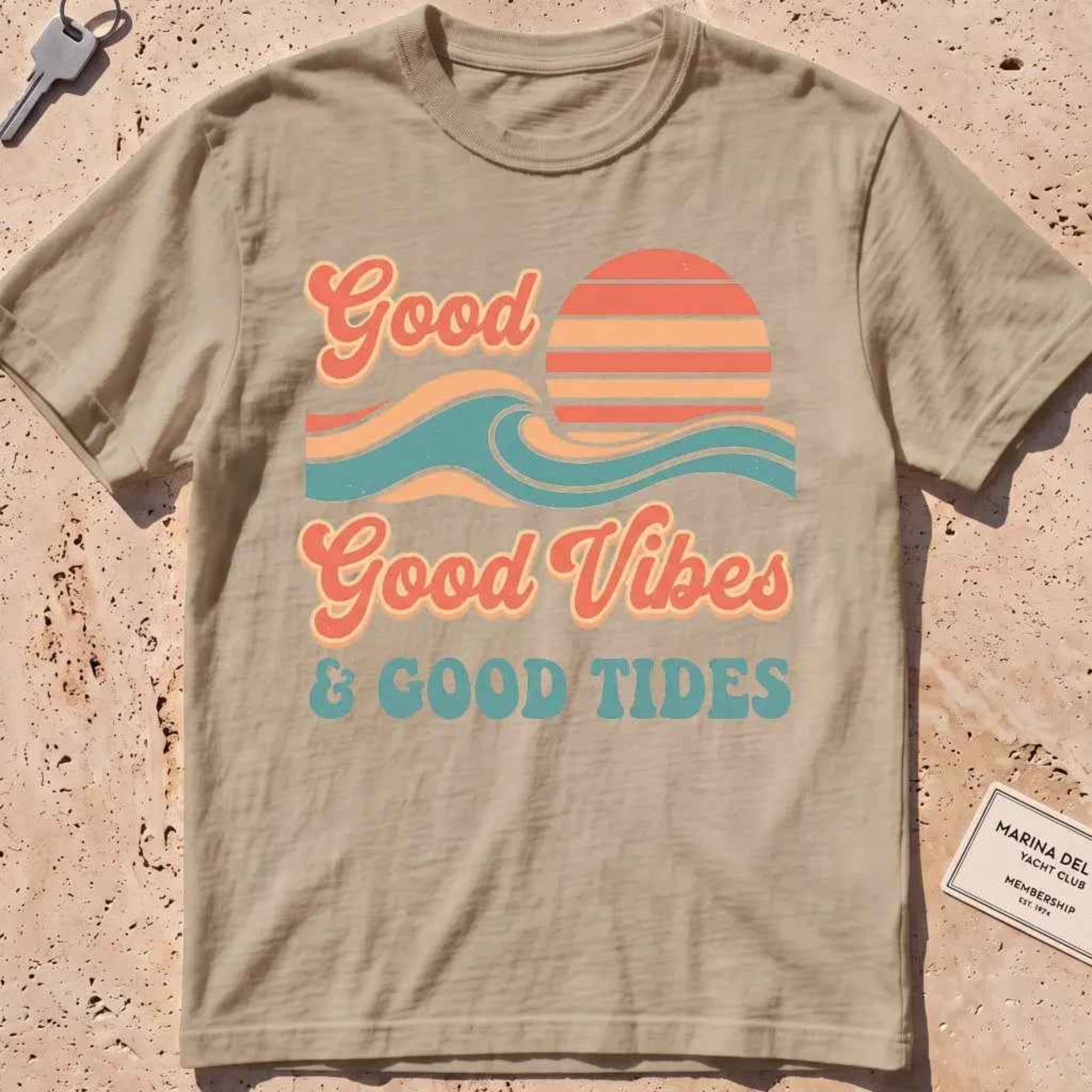 khaki heavyweight tee with retro "Good Vibes and Good Tides" sun-and-wave script.