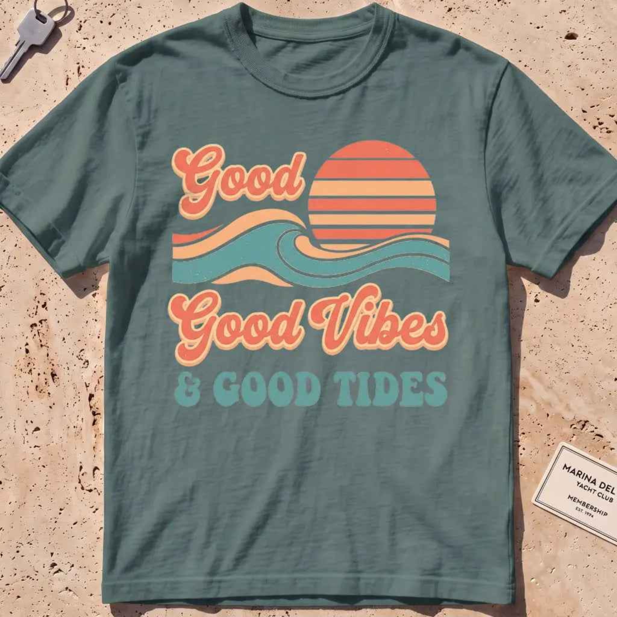 blue spruce heavyweight tee with retro "Good Vibes and Good Tides" sun-and-wave script.