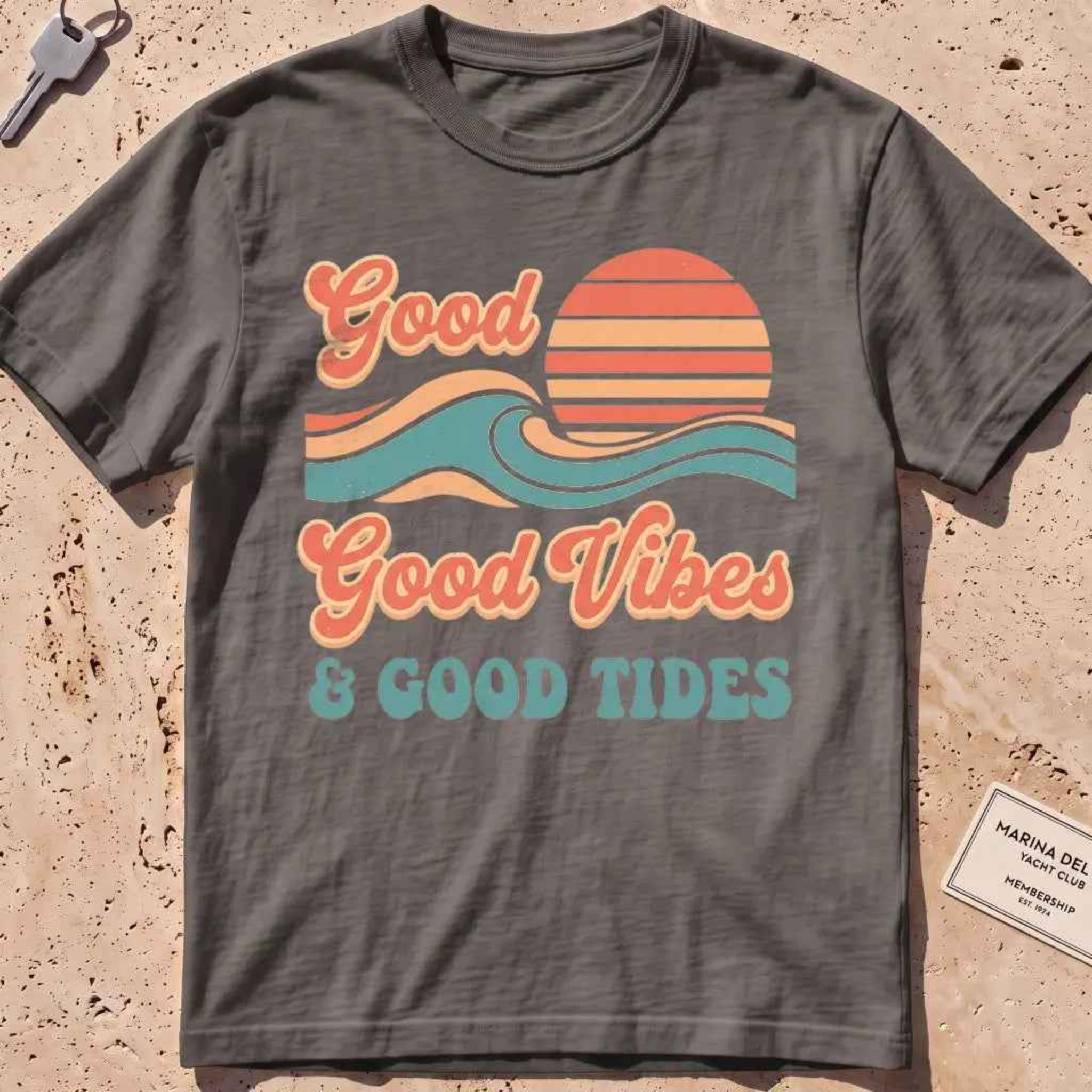 pepper heavyweight tee with retro "Good Vibes and Good Tides" sun-and-wave script.