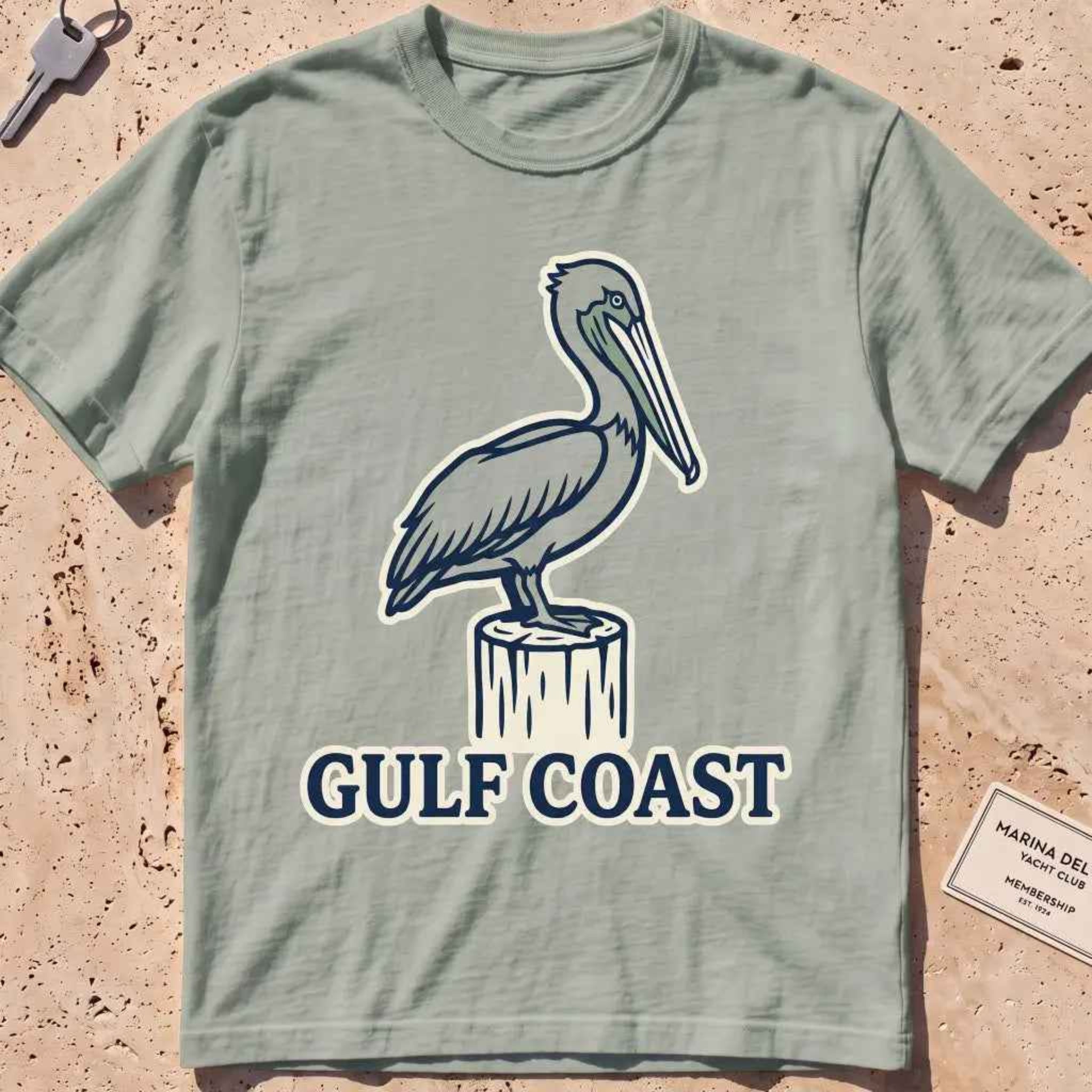 bay heavyweight tee with a pelican perched on a dock piling graphic.
