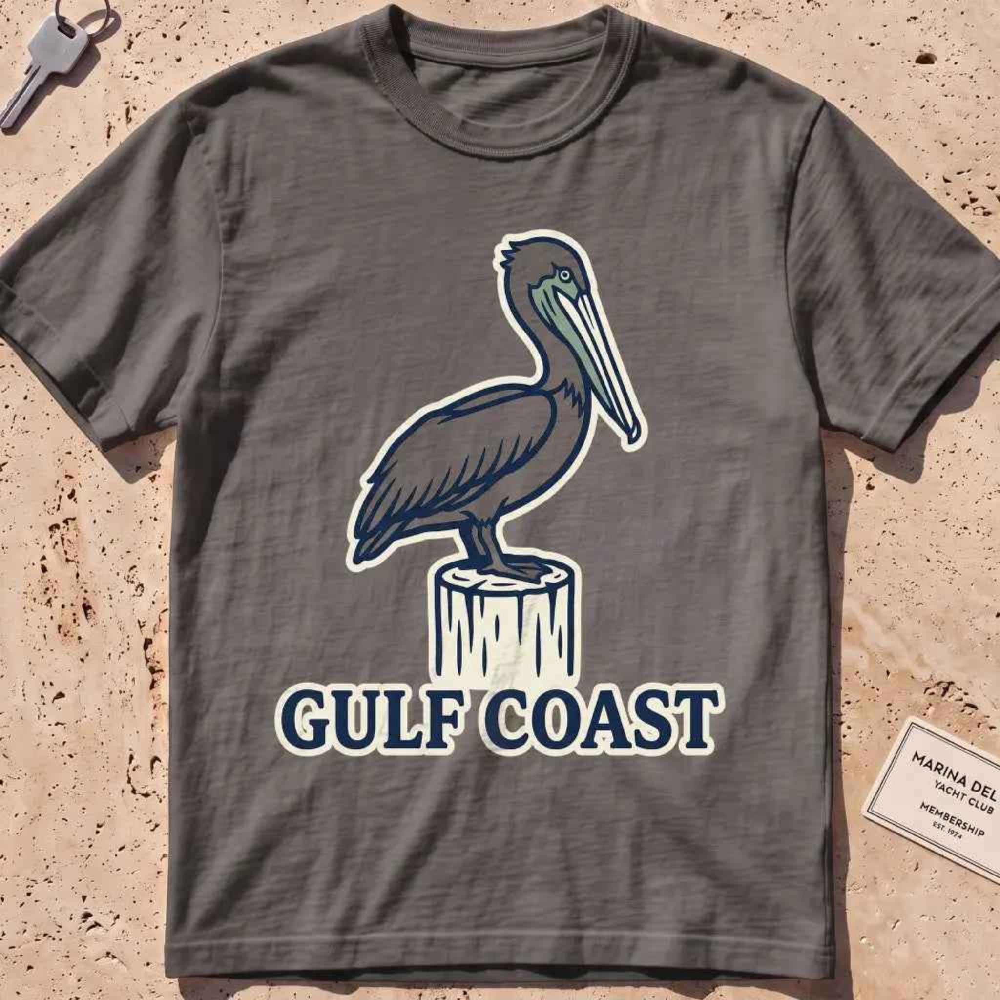 pepper heavyweight tee with a pelican perched on a dock piling graphic.