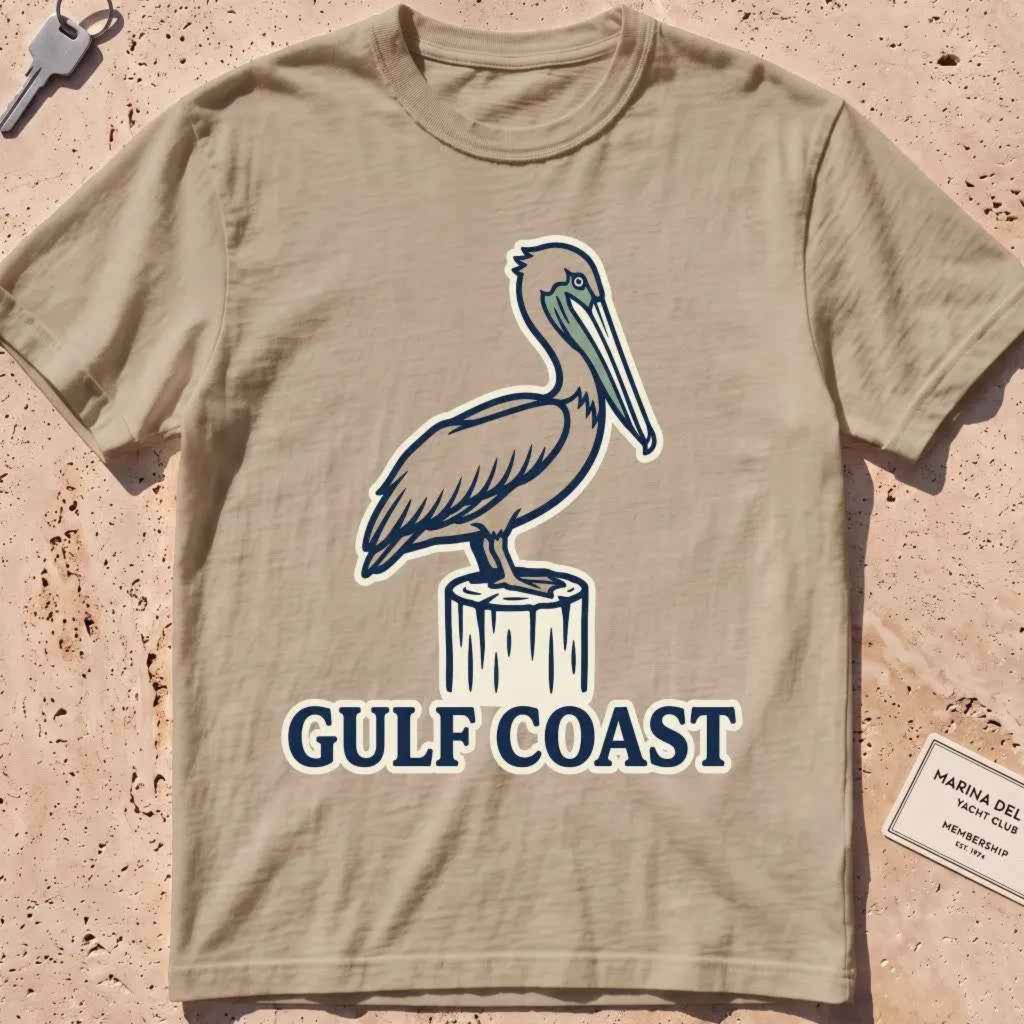 khaki heavyweight tee with a pelican perched on a dock piling graphic.