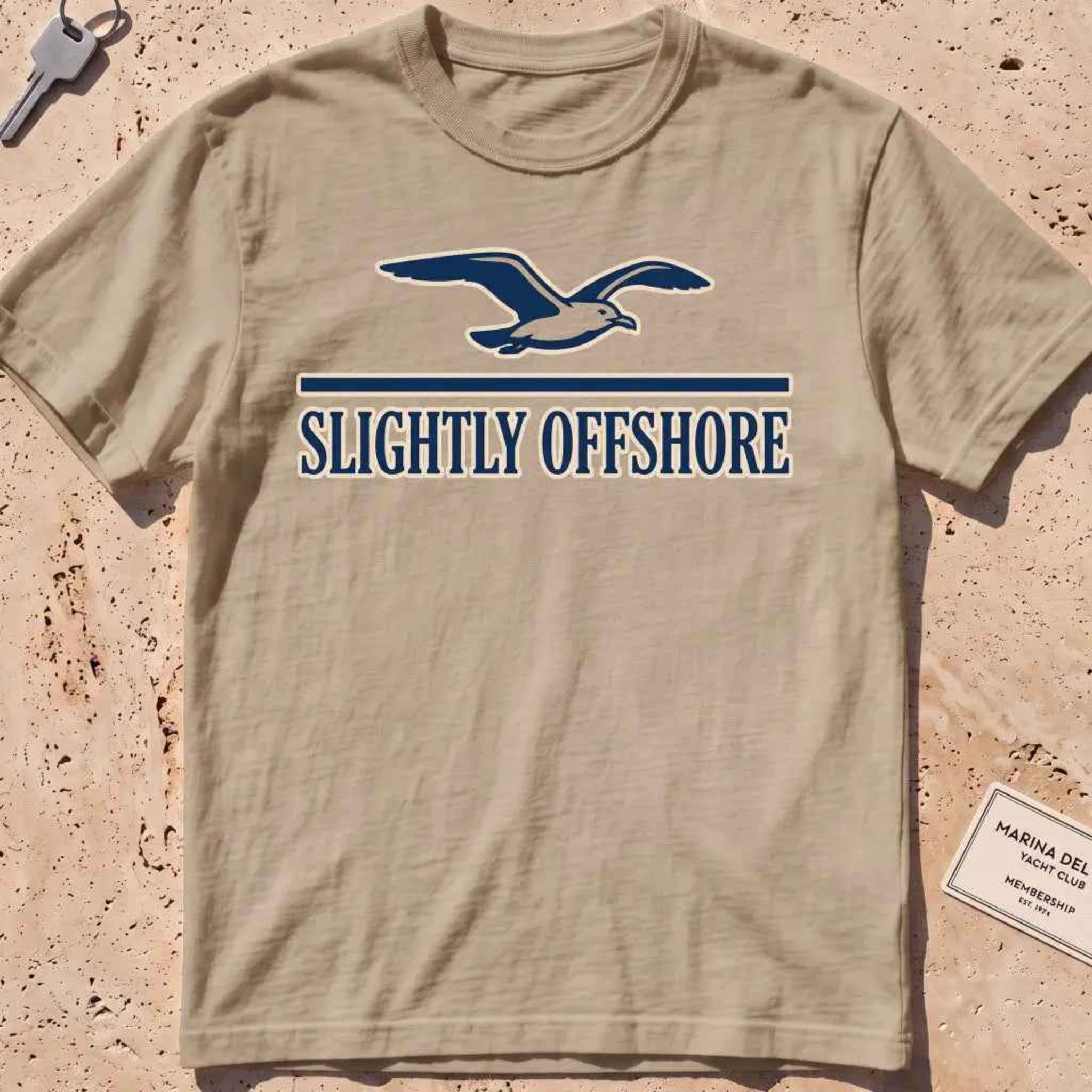 khaki heavyweight tee with a gliding gull over a small wordmark graphic.