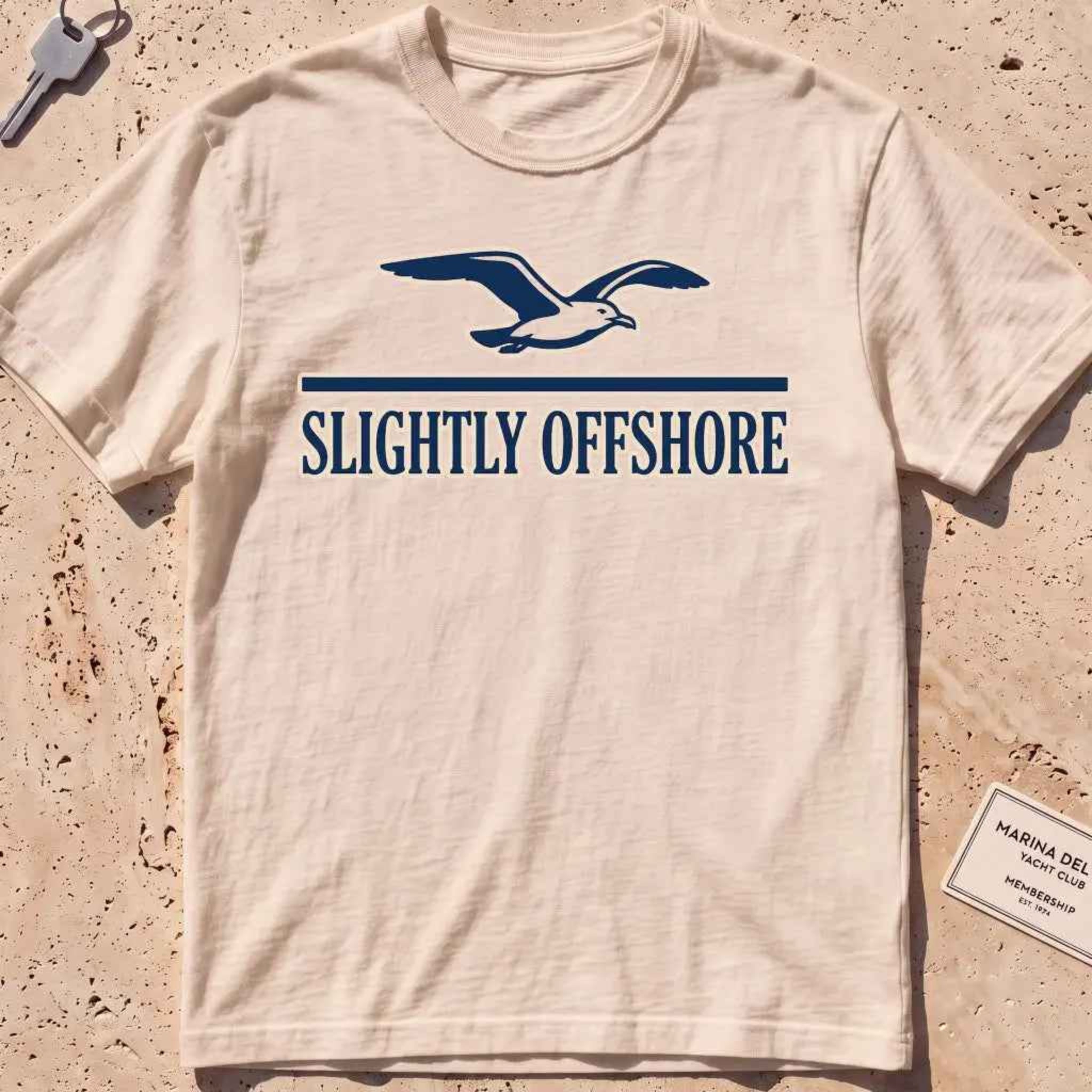 ivory heavyweight tee with a gliding gull over a small wordmark graphic.