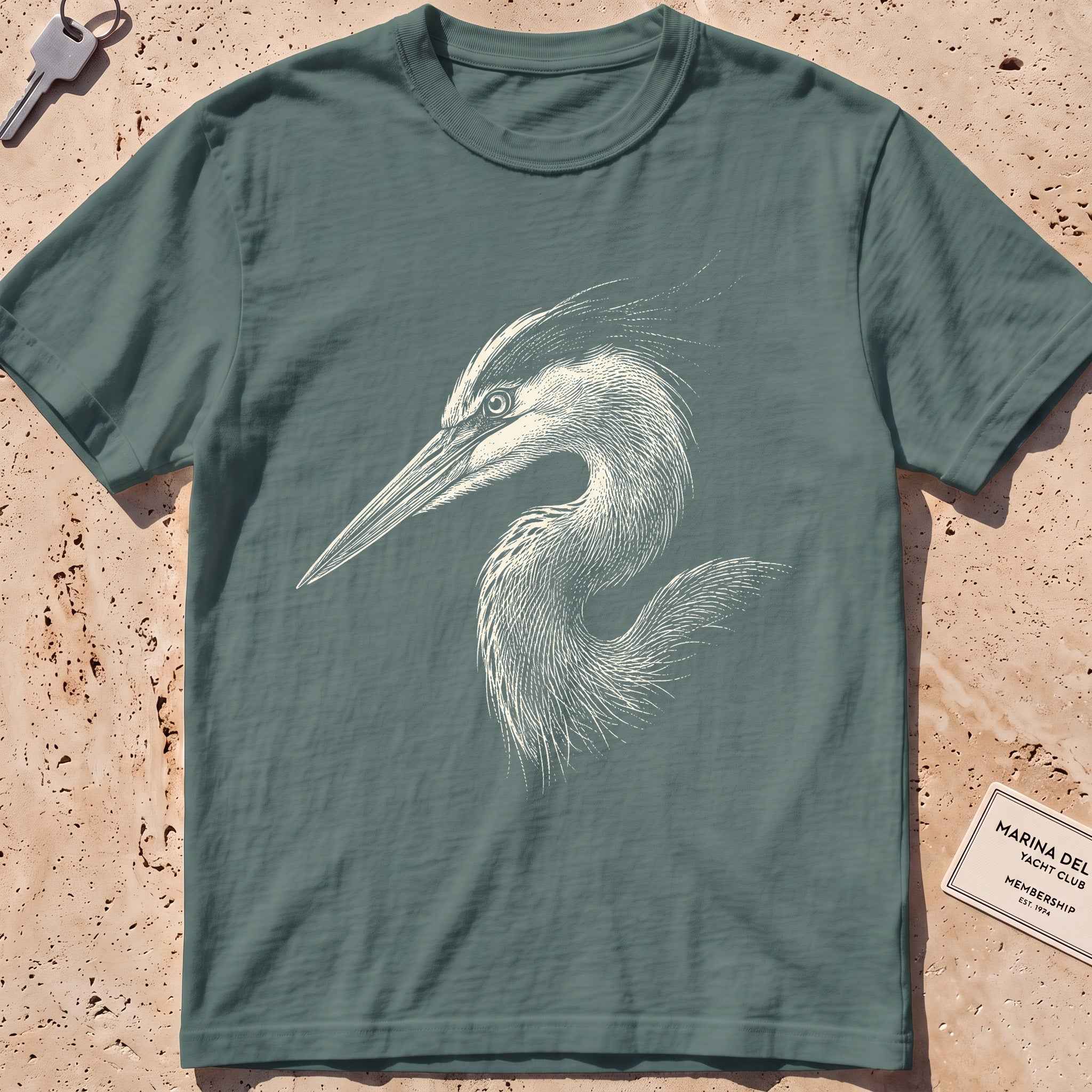 blue spruce heavyweight tee with an etched heron-head portrait graphic.