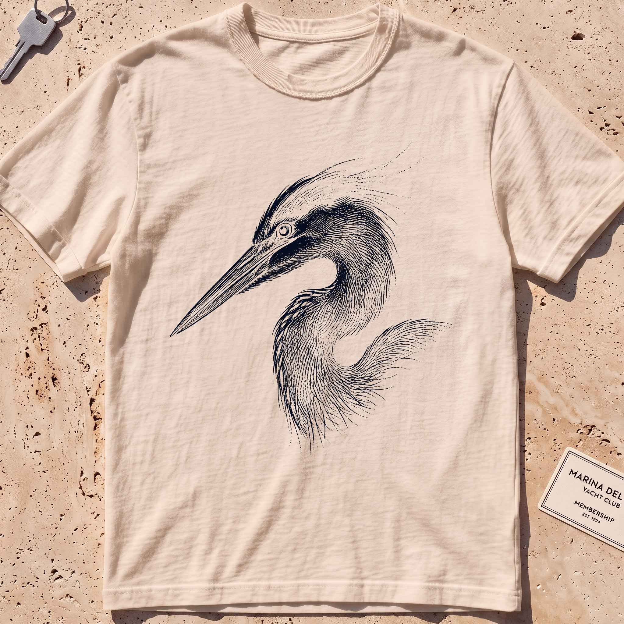 ivory heavyweight tee with an etched heron-head portrait graphic.