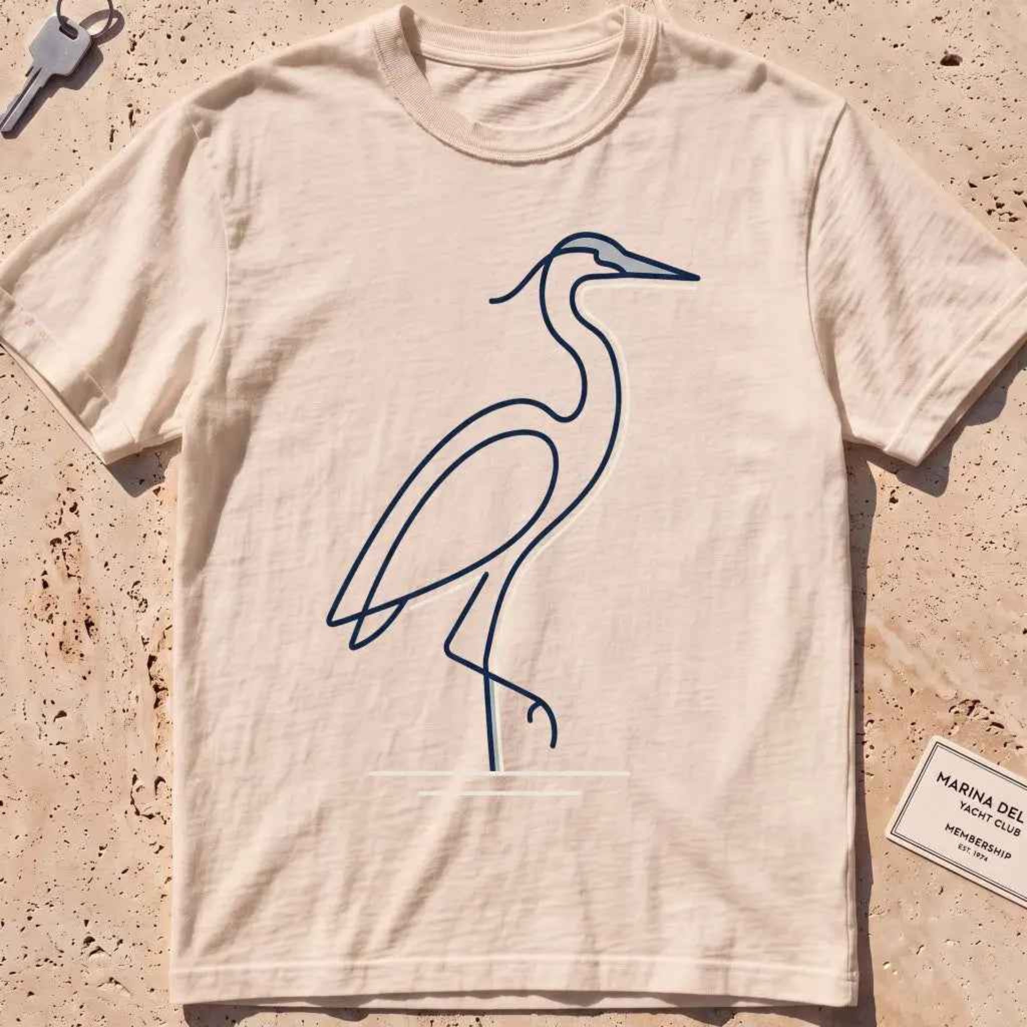 ivory heavyweight tee with a single continuous-line heron standing still graphic.