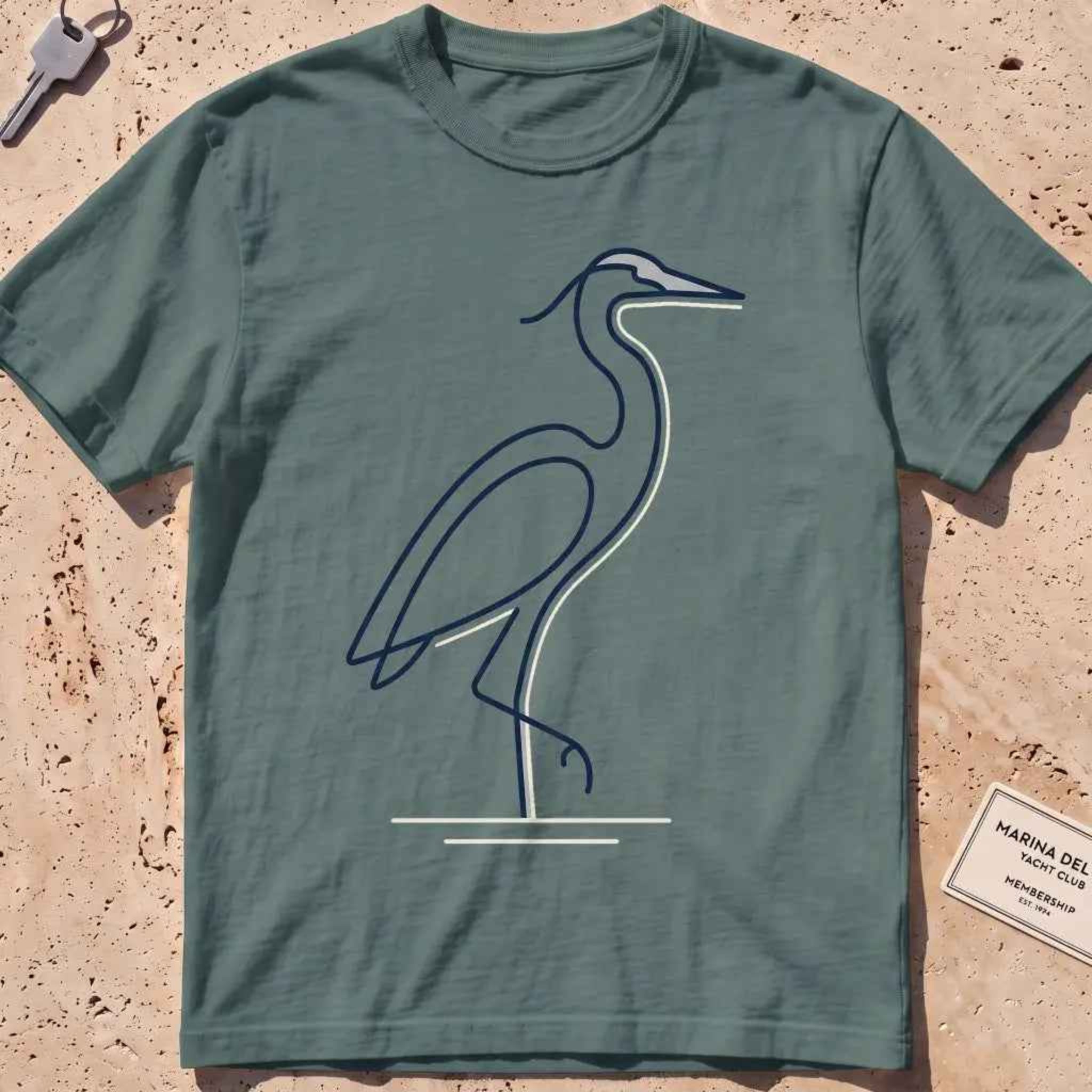 blue spruce heavyweight tee with a single continuous-line heron standing still graphic.