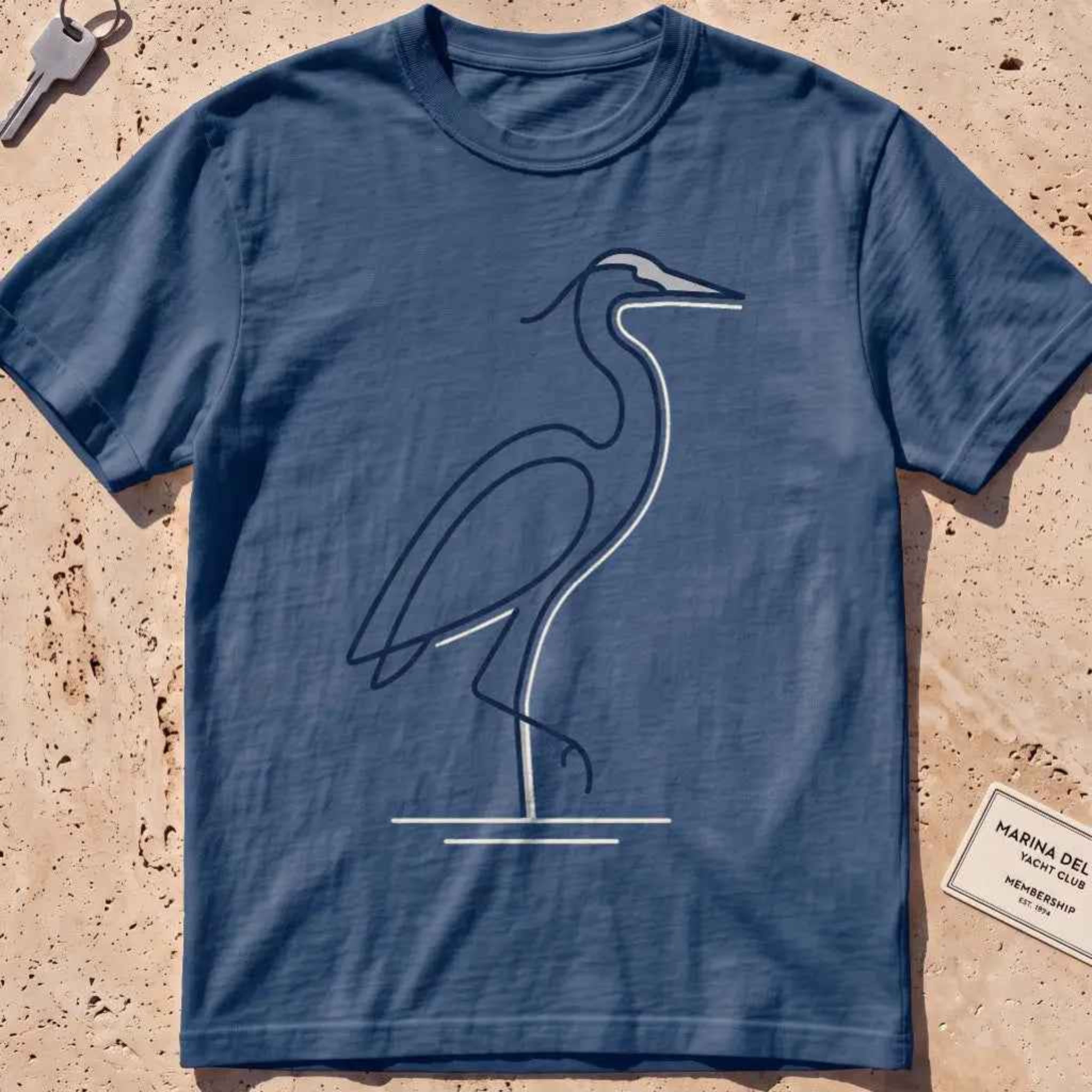 midnight heavyweight tee with a single continuous-line heron standing still graphic.