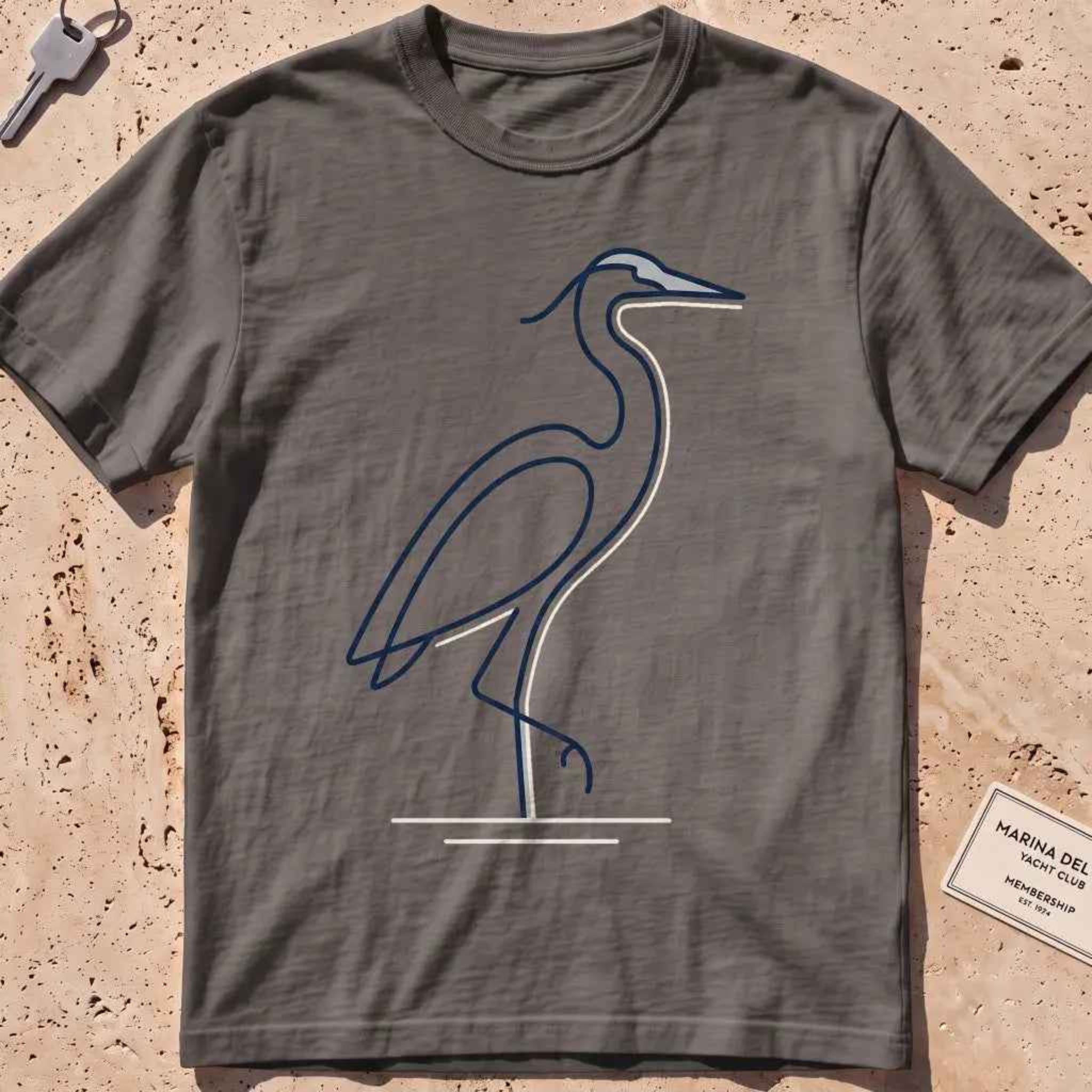 pepper heavyweight tee with a single continuous-line heron standing still graphic.