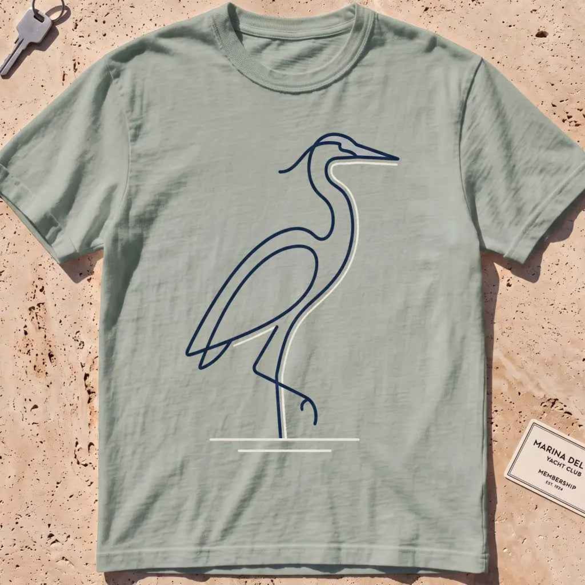 bay heavyweight tee with a single continuous-line heron standing still graphic.