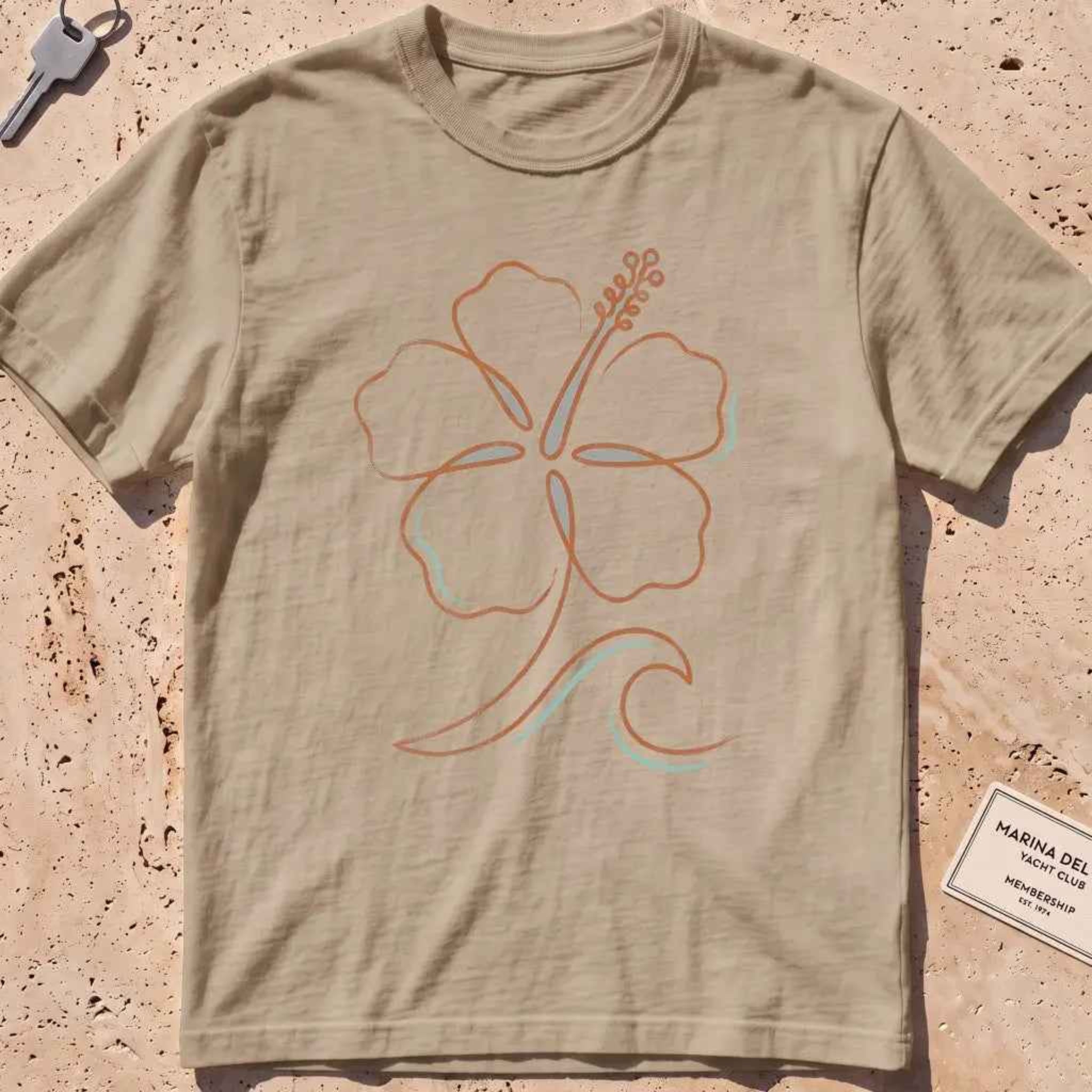 khaki heavyweight tee with a single-line hibiscus and small wave graphic.