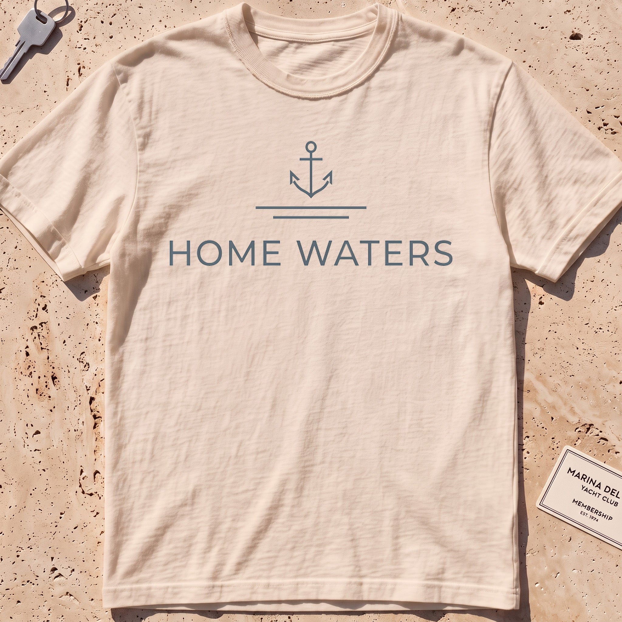 ivory heavyweight tee with a minimal anchor and "Home Waters" wordmark.