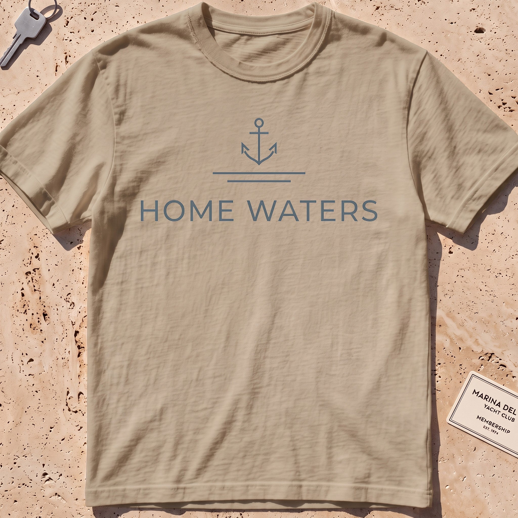 khaki heavyweight tee with a minimal anchor and "Home Waters" wordmark.
