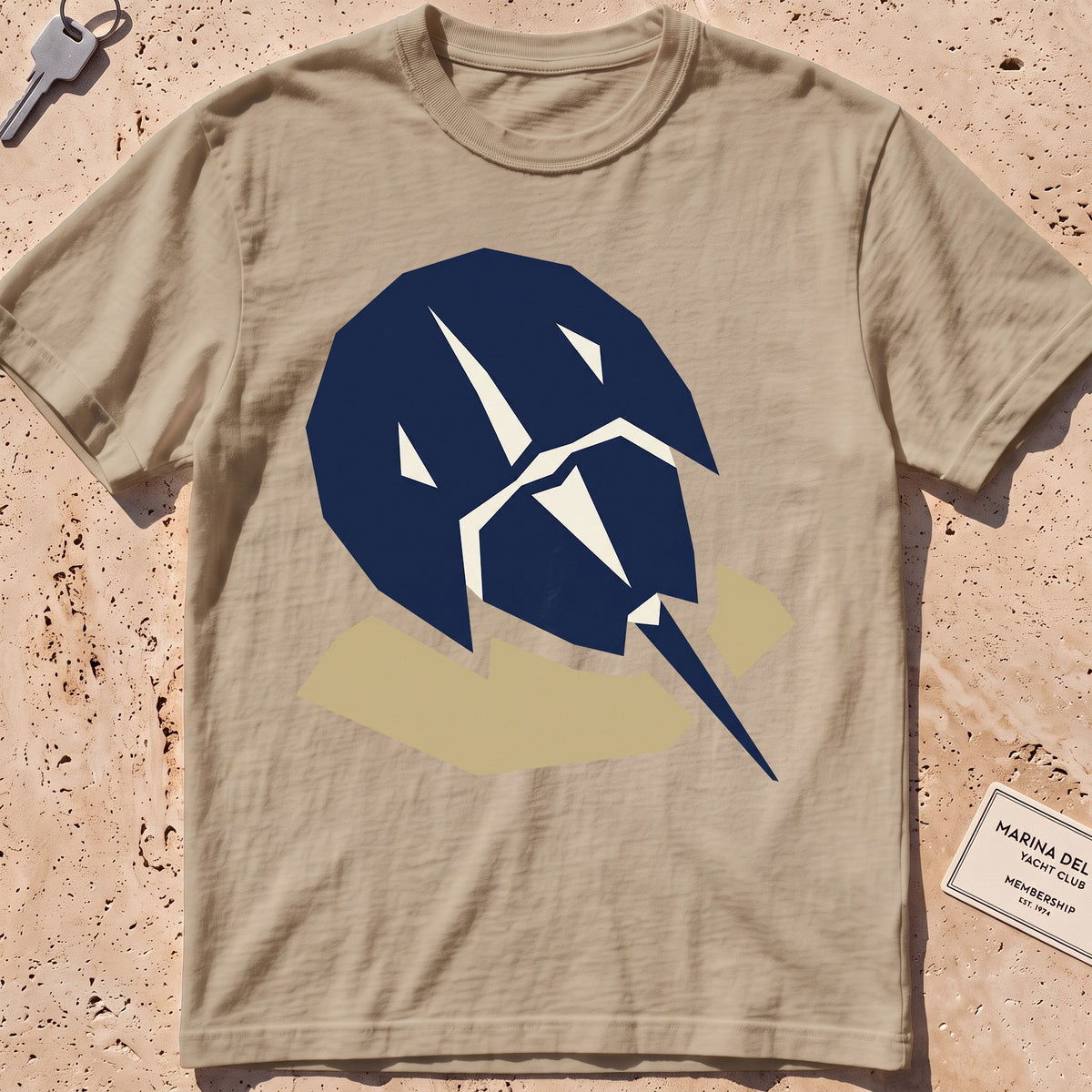 khaki heavyweight tee with a flat-geometric horseshoe crab graphic.