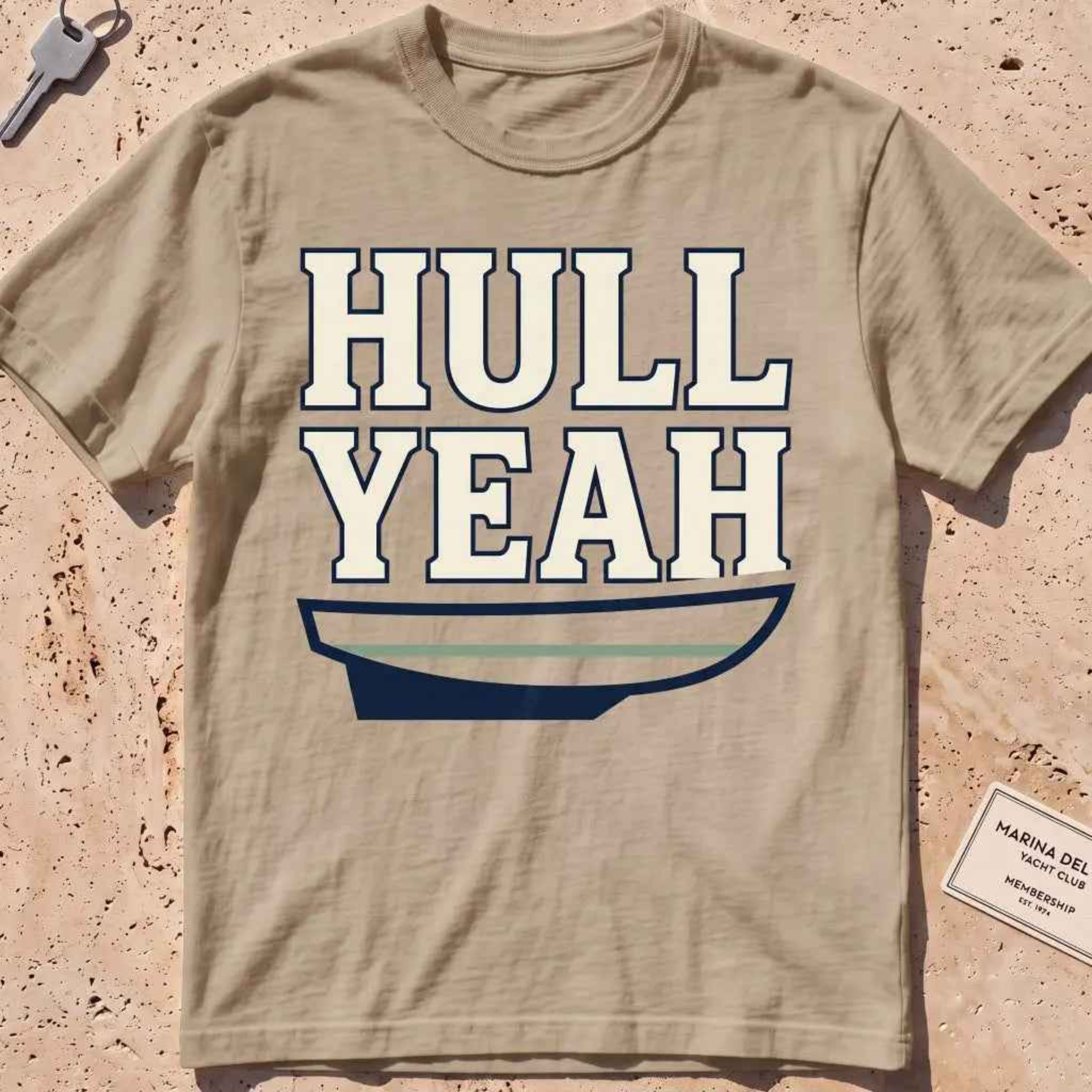 khaki heavyweight tee with a boat hull and bold "Hull Yeah" nautical pun type.