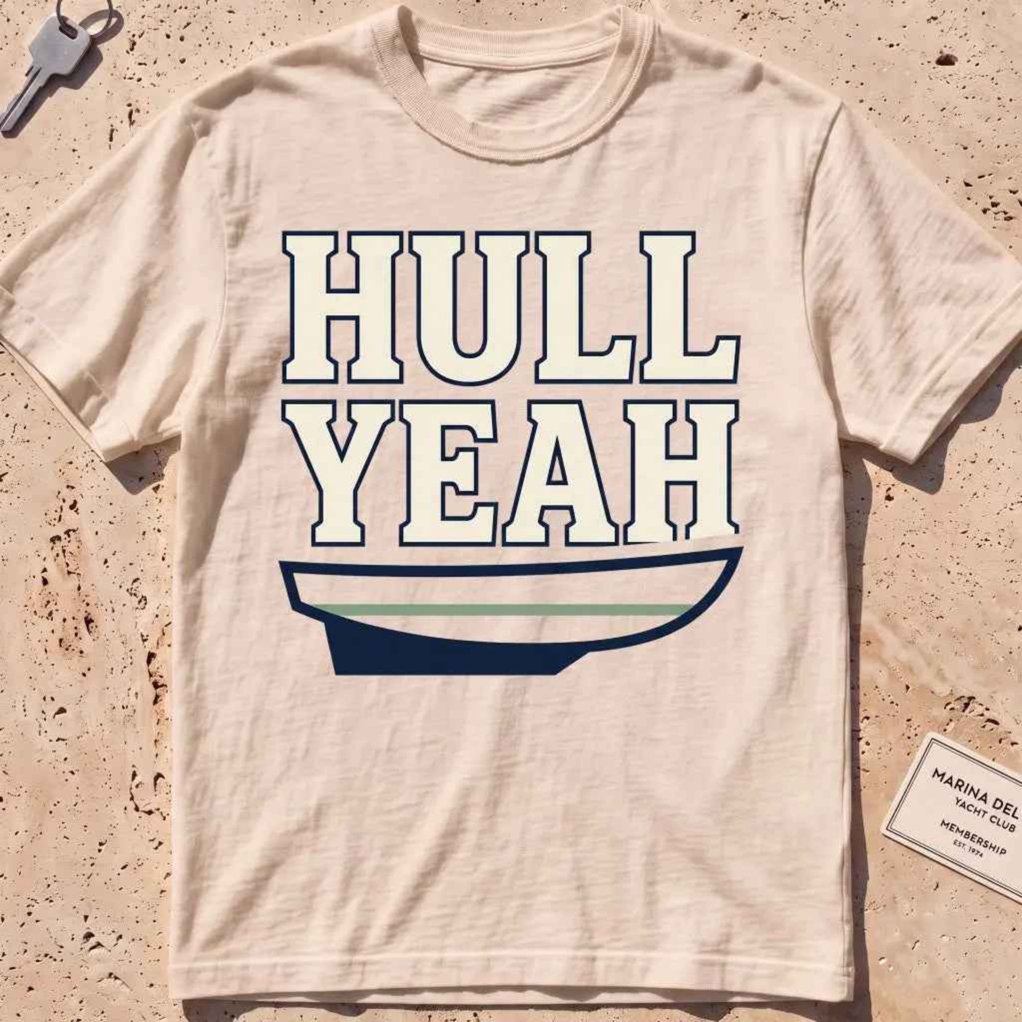 ivory heavyweight tee with a boat hull and bold "Hull Yeah" nautical pun type.