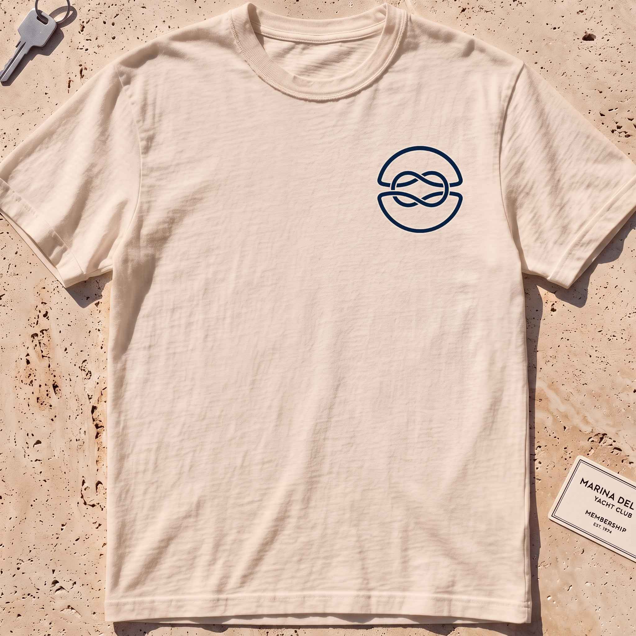 ivory heavyweight tee with a clean overhand-knot crest graphic.