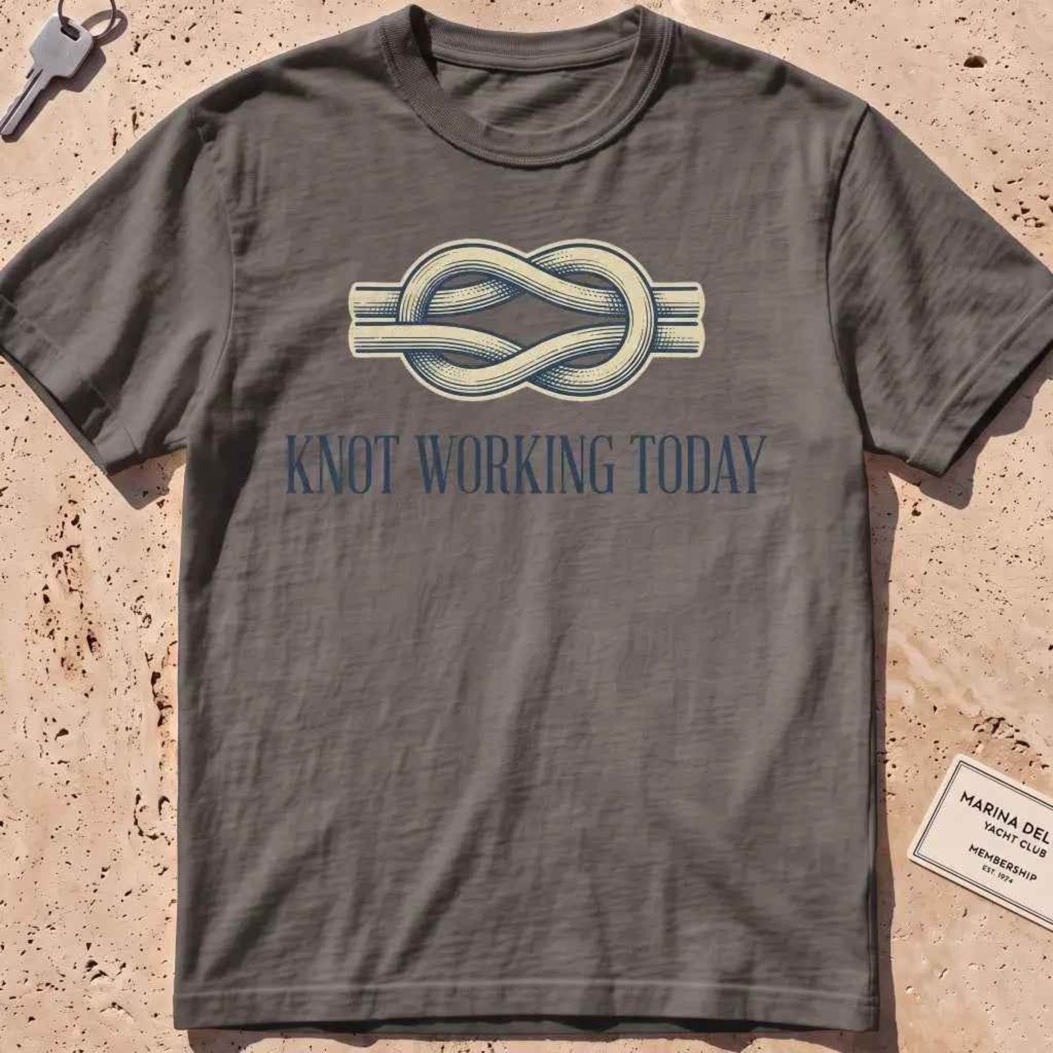 pepper heavyweight tee with an engraved knot and "Knot Working Today" text.