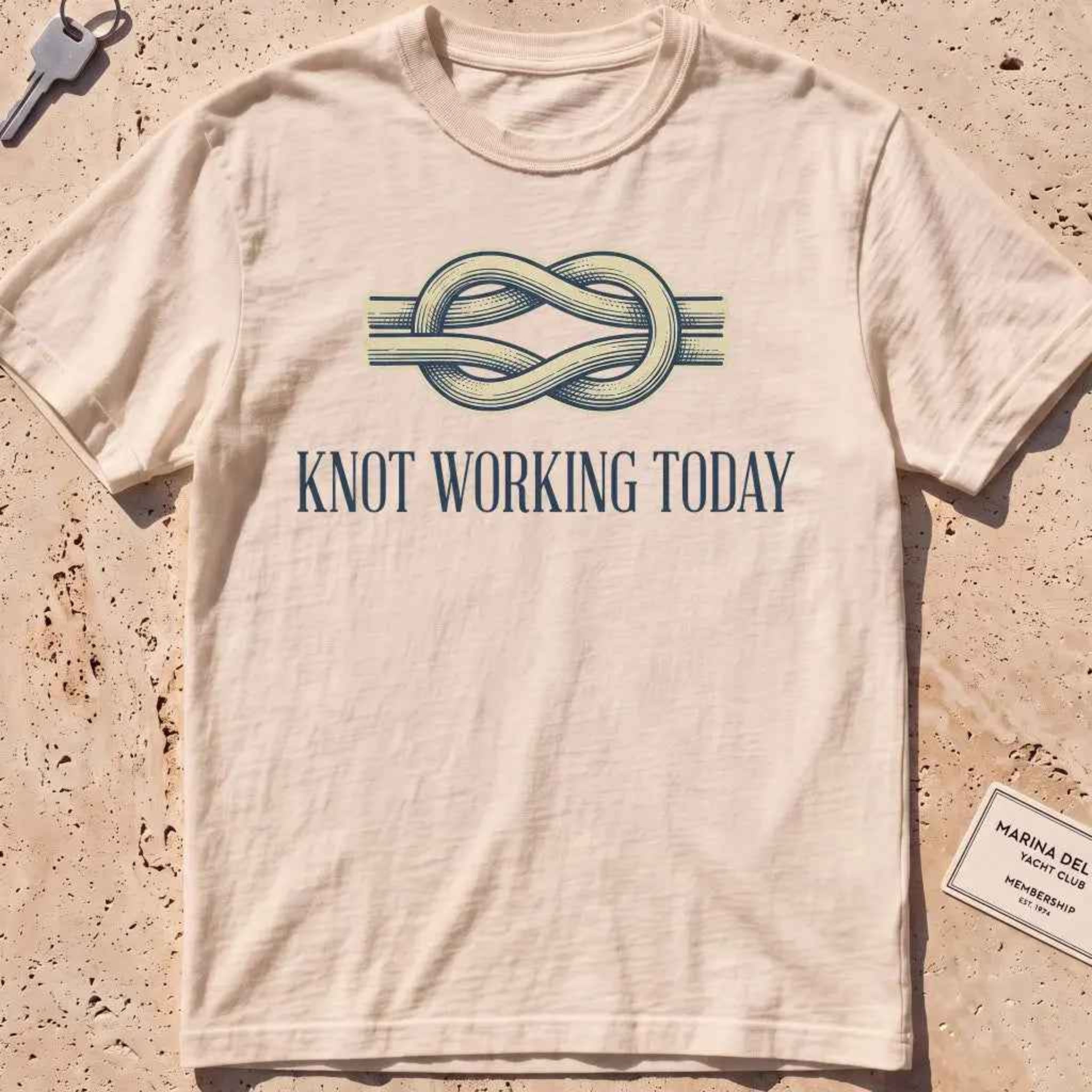 ivory heavyweight tee with an engraved knot and "Knot Working Today" text.