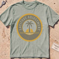 bay heavyweight tee with a palm-and-sun "Latitude Adjustment" badge.