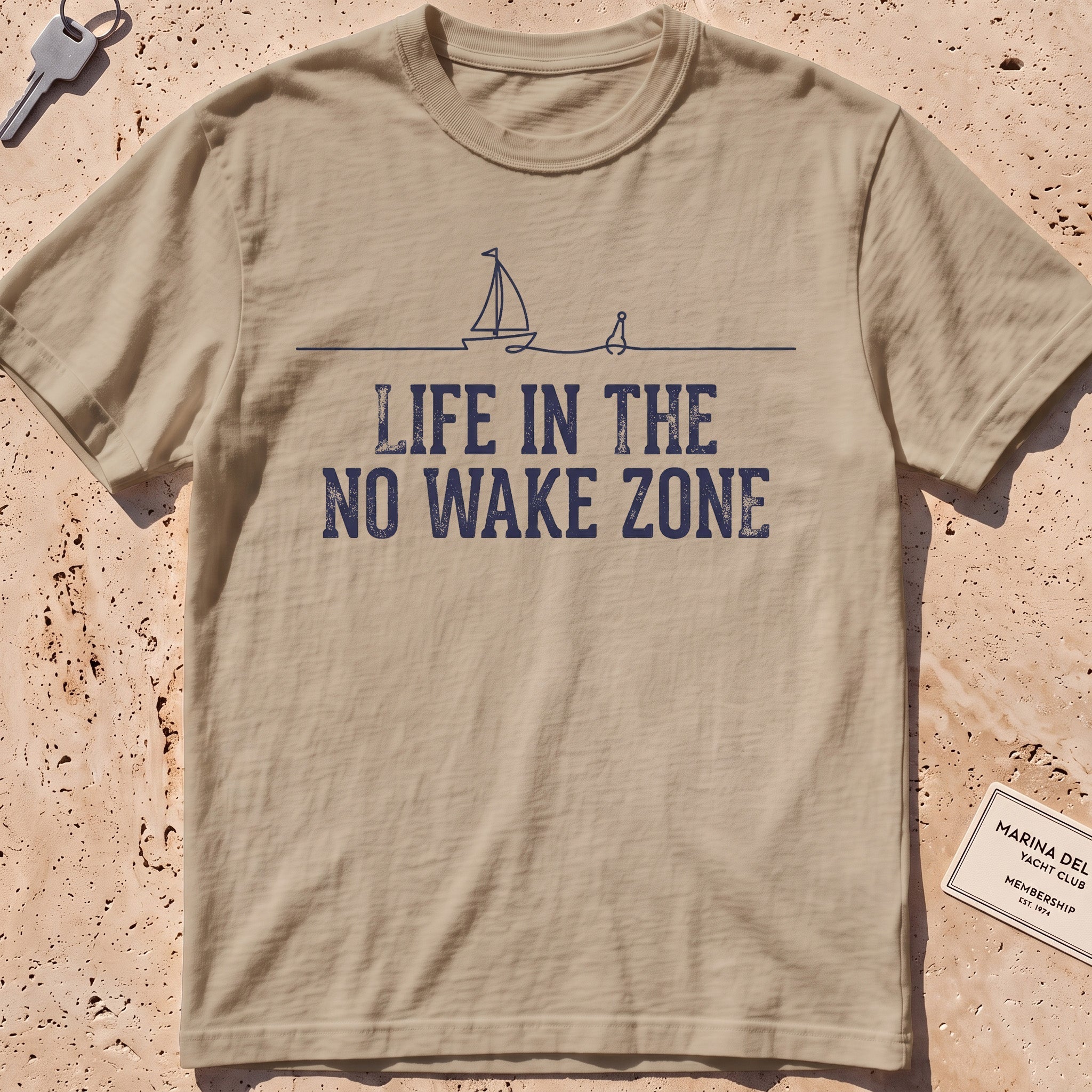 Khaki heavyweight tee with a single-line sailboat, buoy and "No Wake Zone" text.