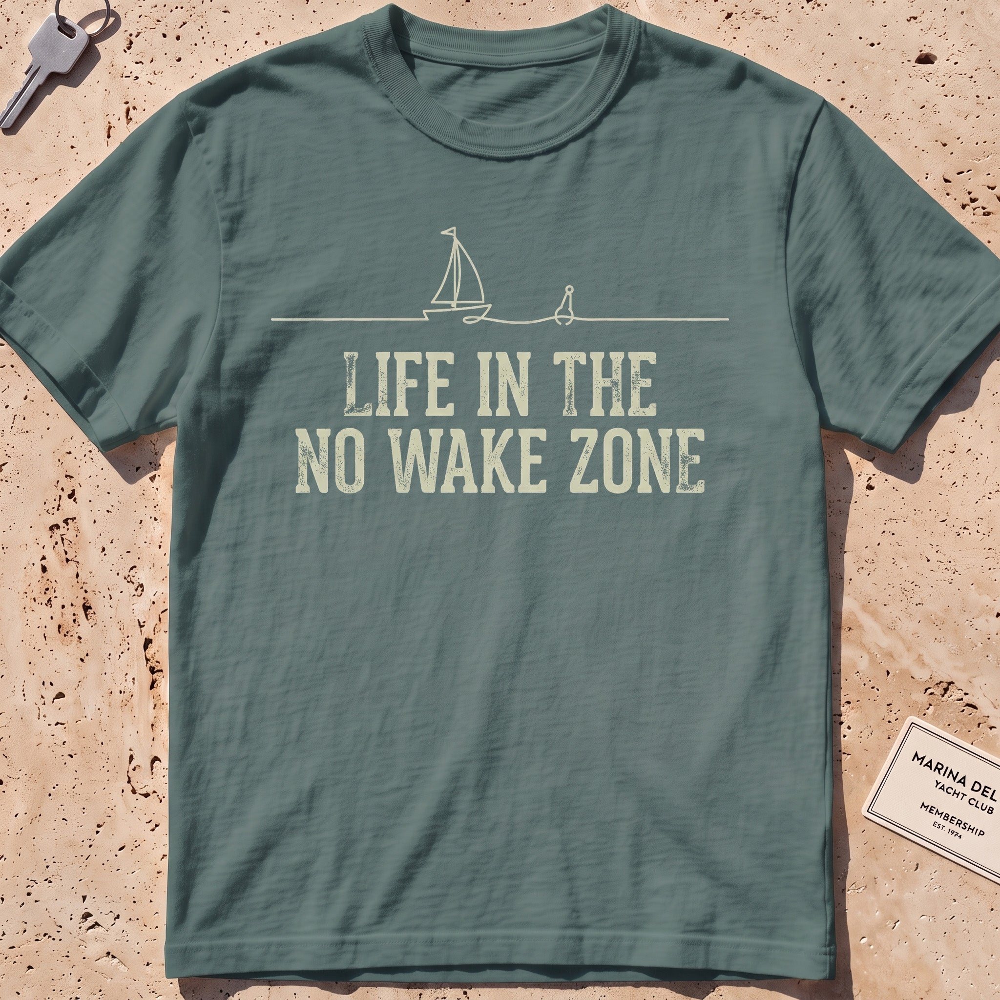 blue spruce heavyweight tee with a single-line sailboat, buoy and "No Wake Zone" text.