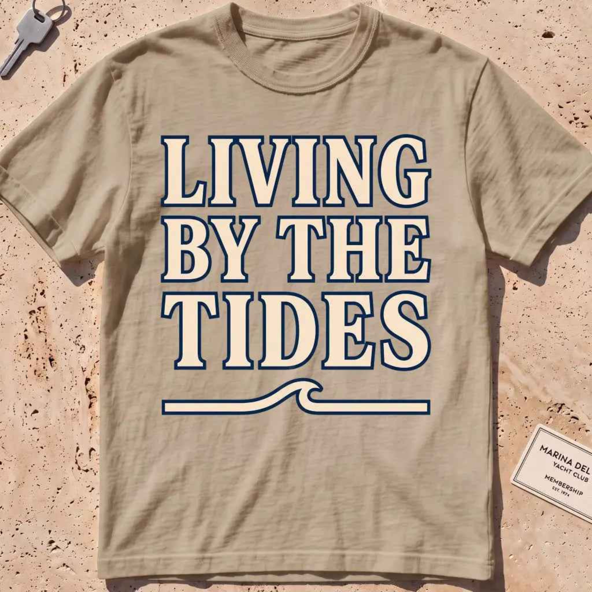 khaki heavyweight tee with "Living by the Tides" type over a swell rule.