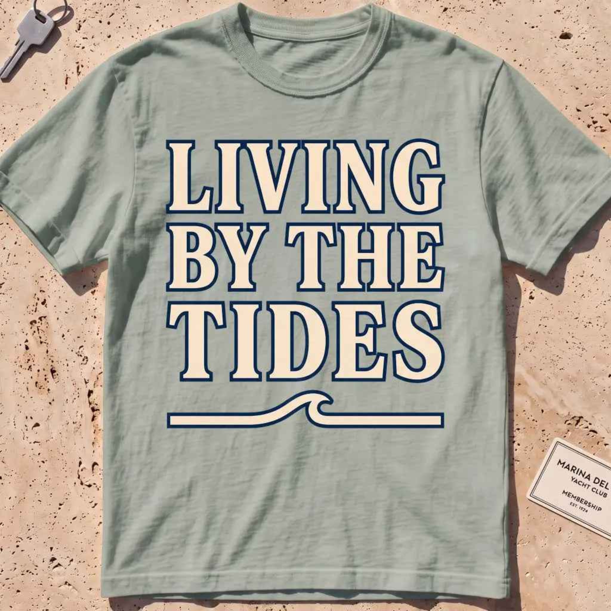 bay heavyweight tee with "Living by the Tides" type over a swell rule.