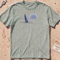 bay heavyweight tee with a lone sail against a rising sun in minimal style.