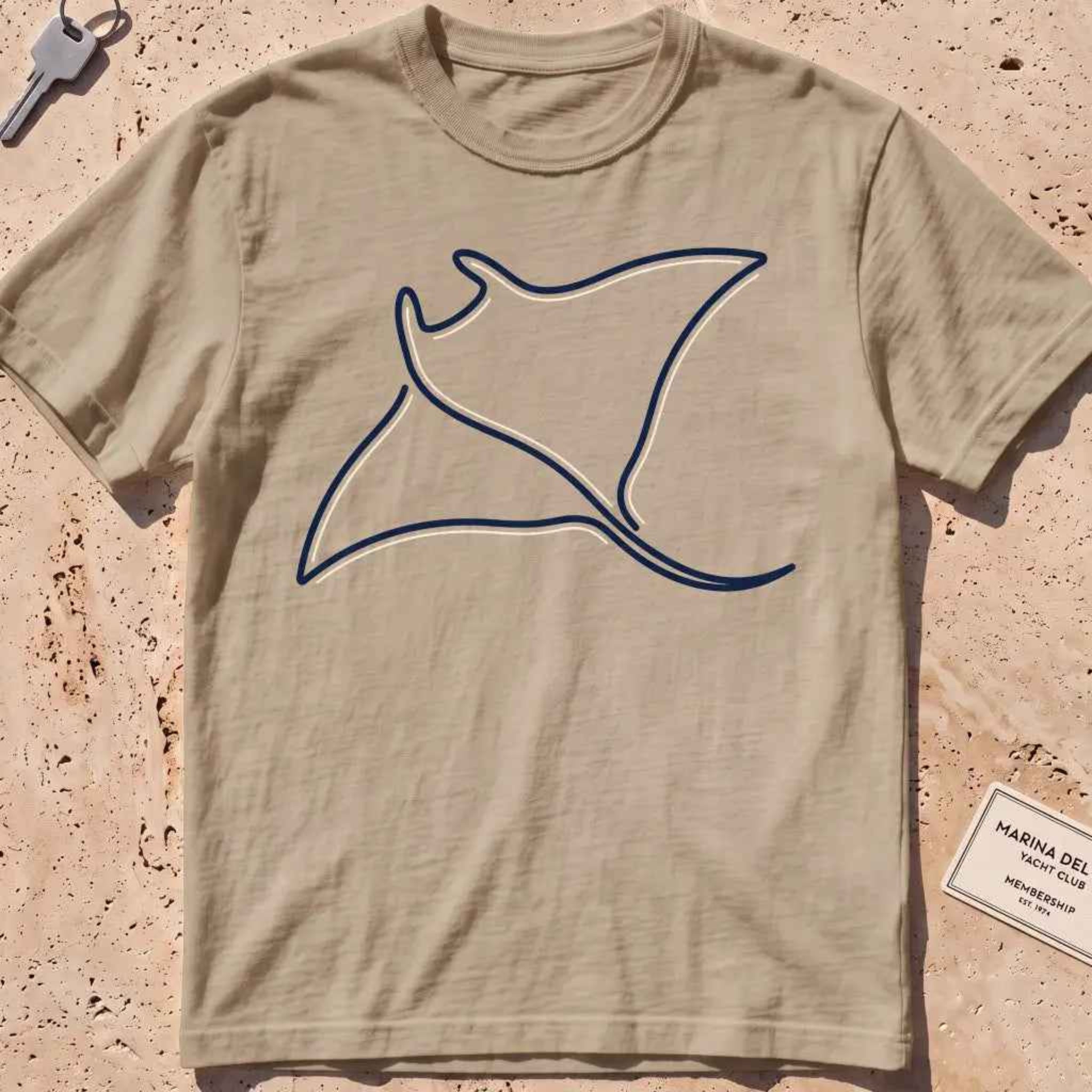 khaki heavyweight tee with a single continuous-line manta ray graphic.