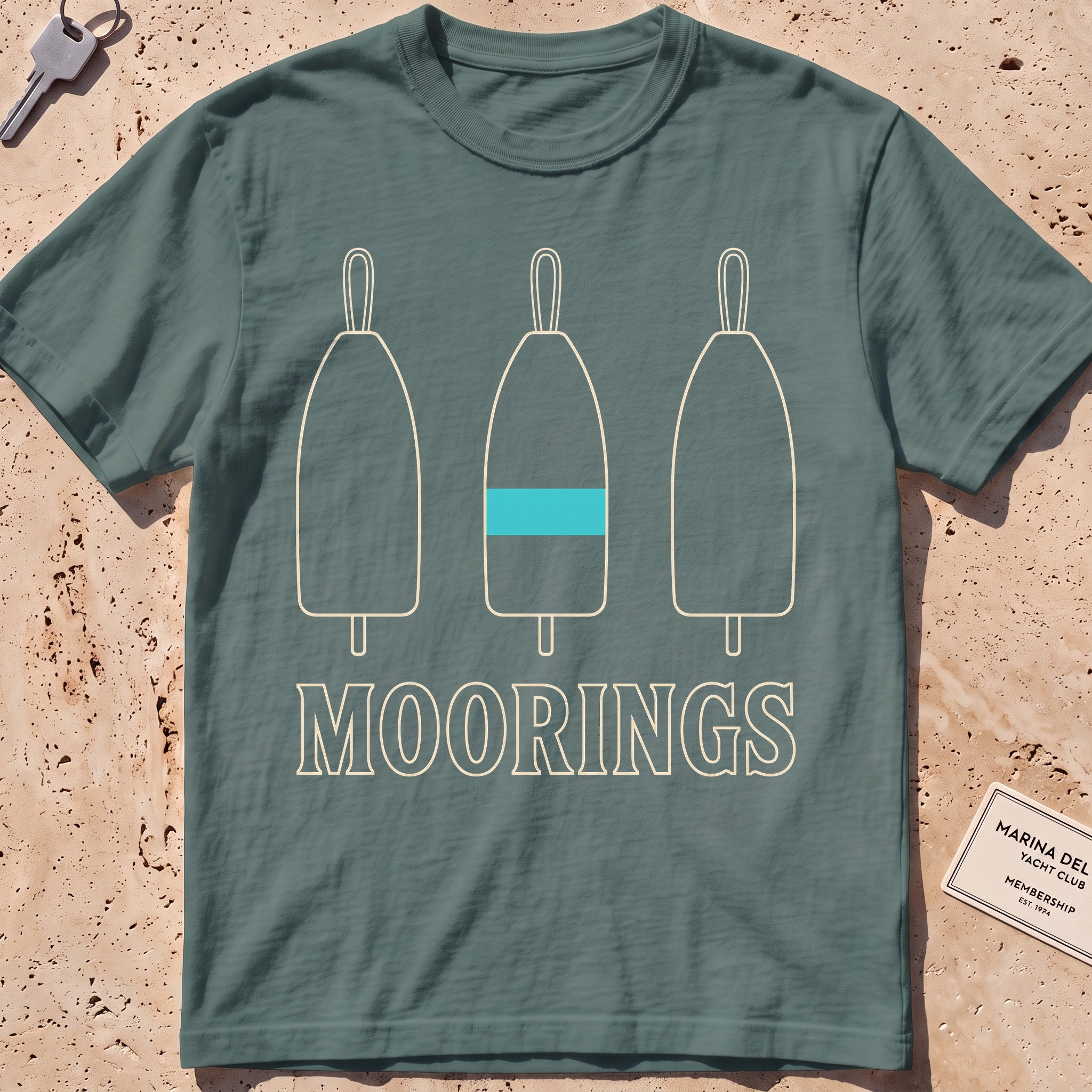 blue spruce heavyweight tee with three mooring buoys and "Moorings" text.
