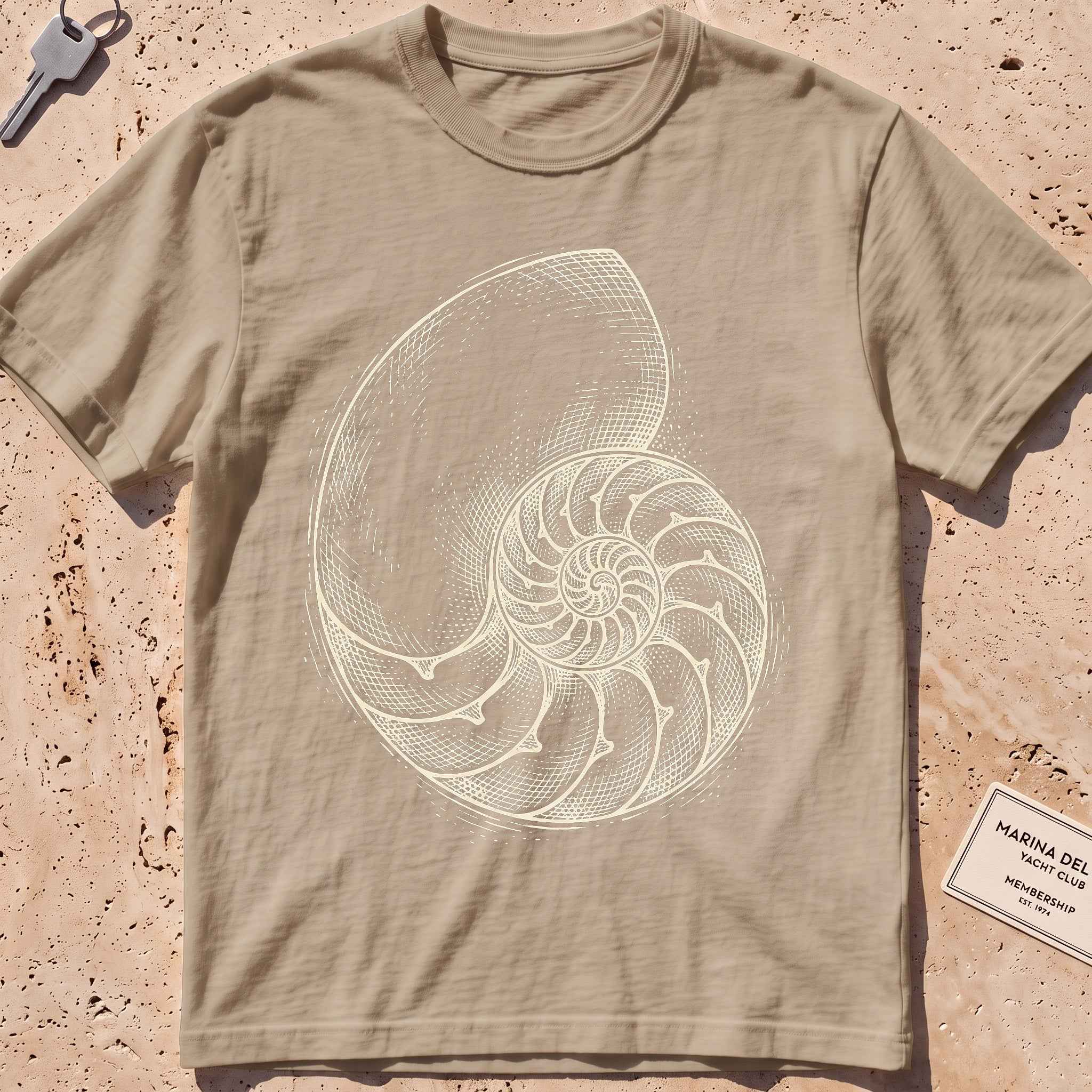 khaki heavyweight tee with an etched nautilus shell graphic.