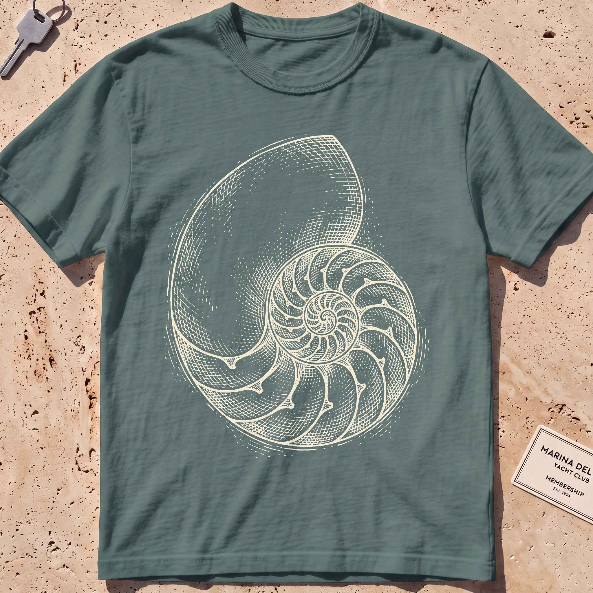 blue spruce heavyweight tee with an etched nautilus shell graphic.