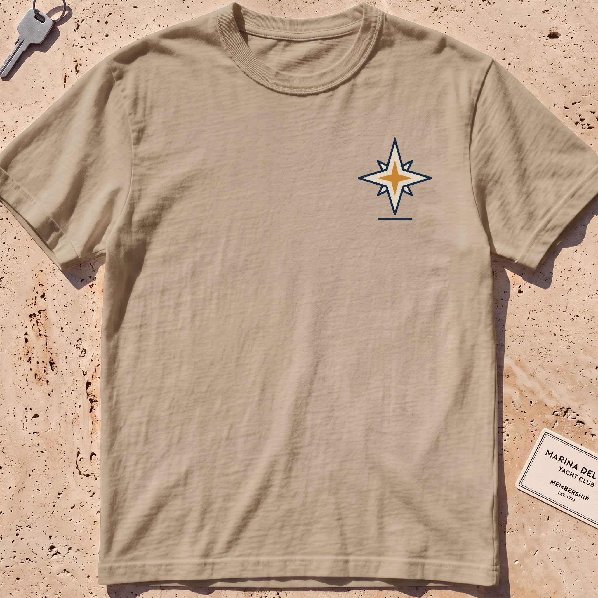 khaki heavyweight tee with a compass-star "North Star" crest graphic.