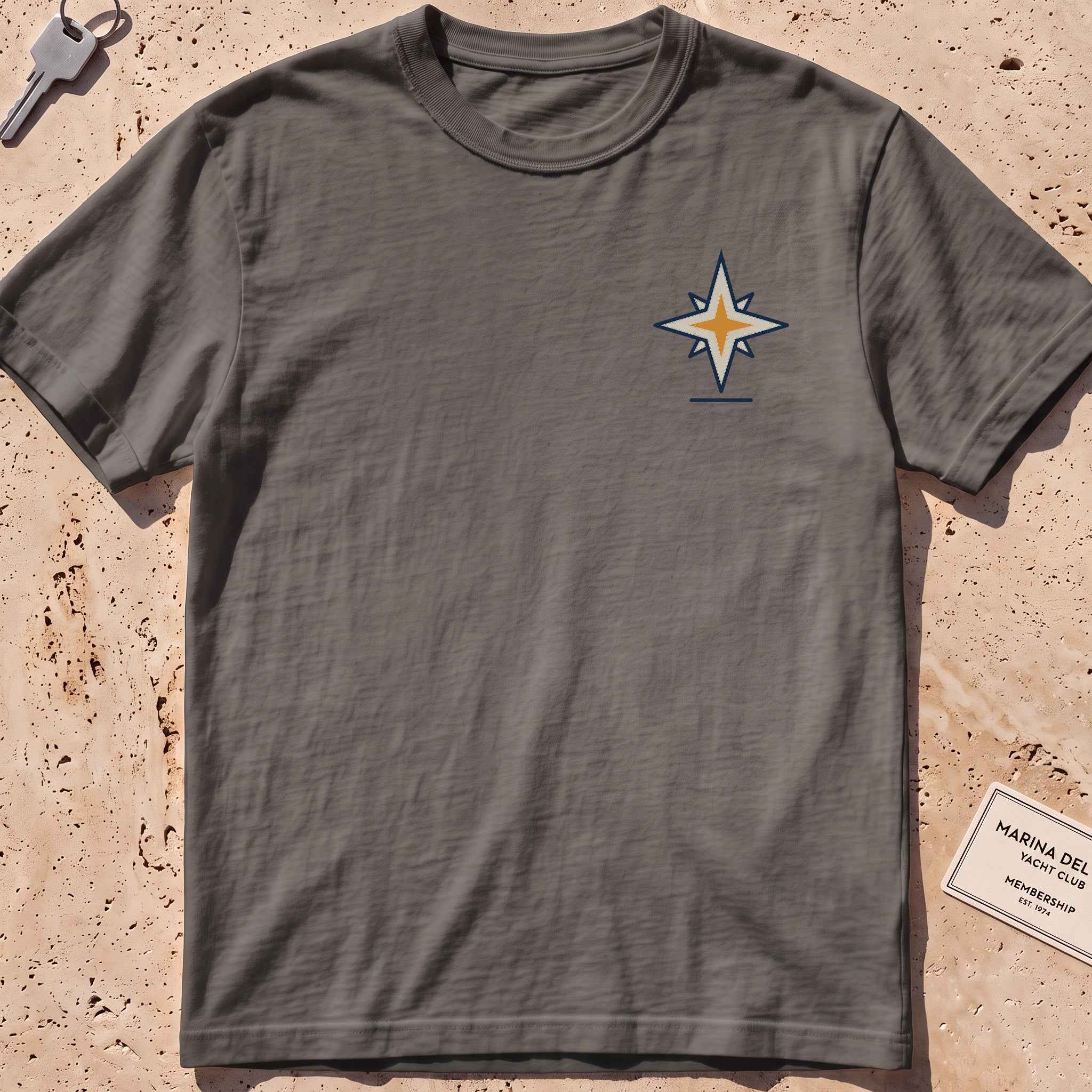 pepper heavyweight tee with a compass-star "North Star" crest graphic.